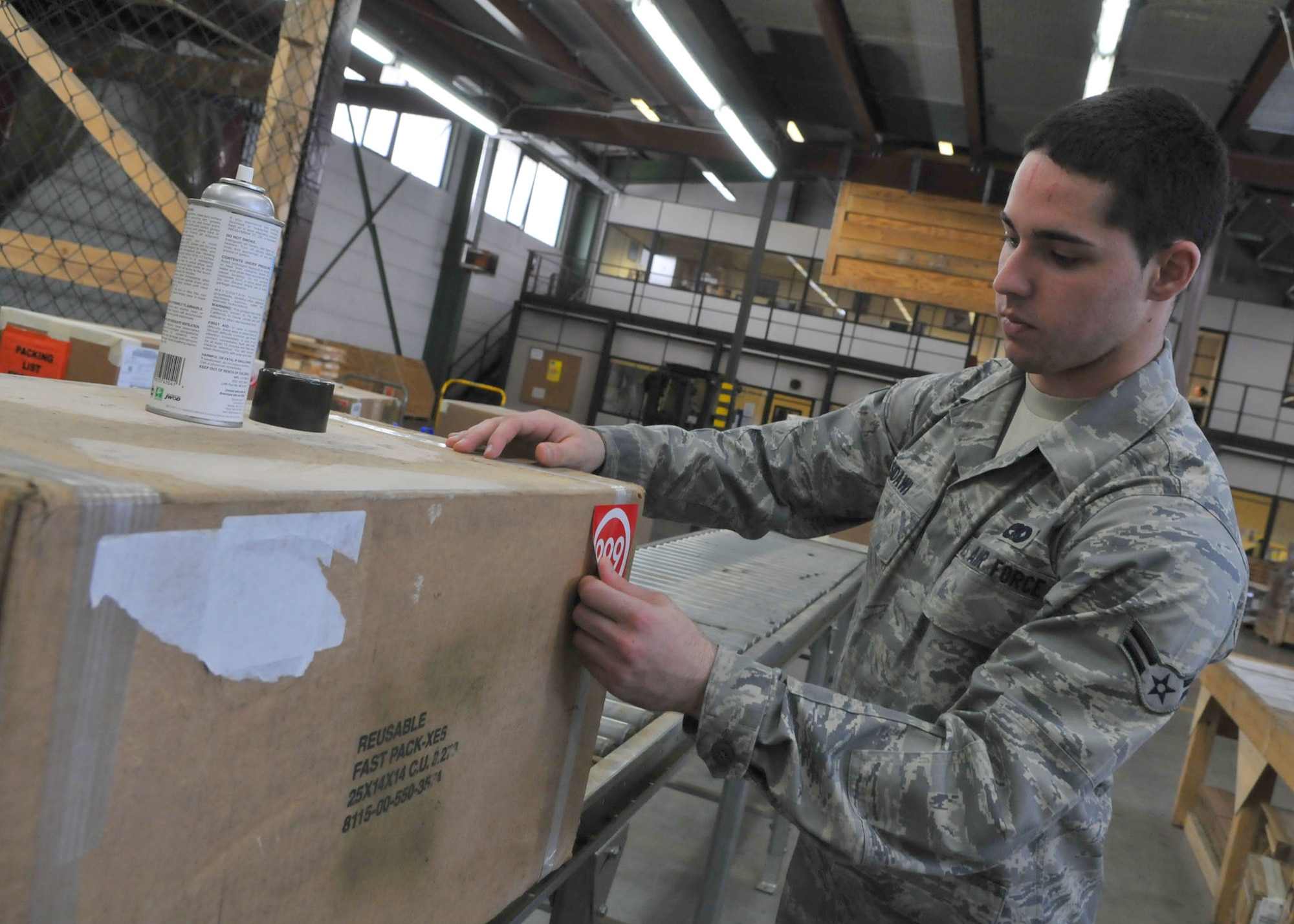 SPANGDAHLEM AIR BASE, Germany – Airman 1st Class Ryan Sidawi, 52nd Logistics Readiness Squadron travel management office, prepares  cargo for out-processing and shipment. The TMO office is open 8 a.m. – 4 p.m. Monday through Friday. (U.S. Air Force photo by Airman 1st Class Nick Wilson)