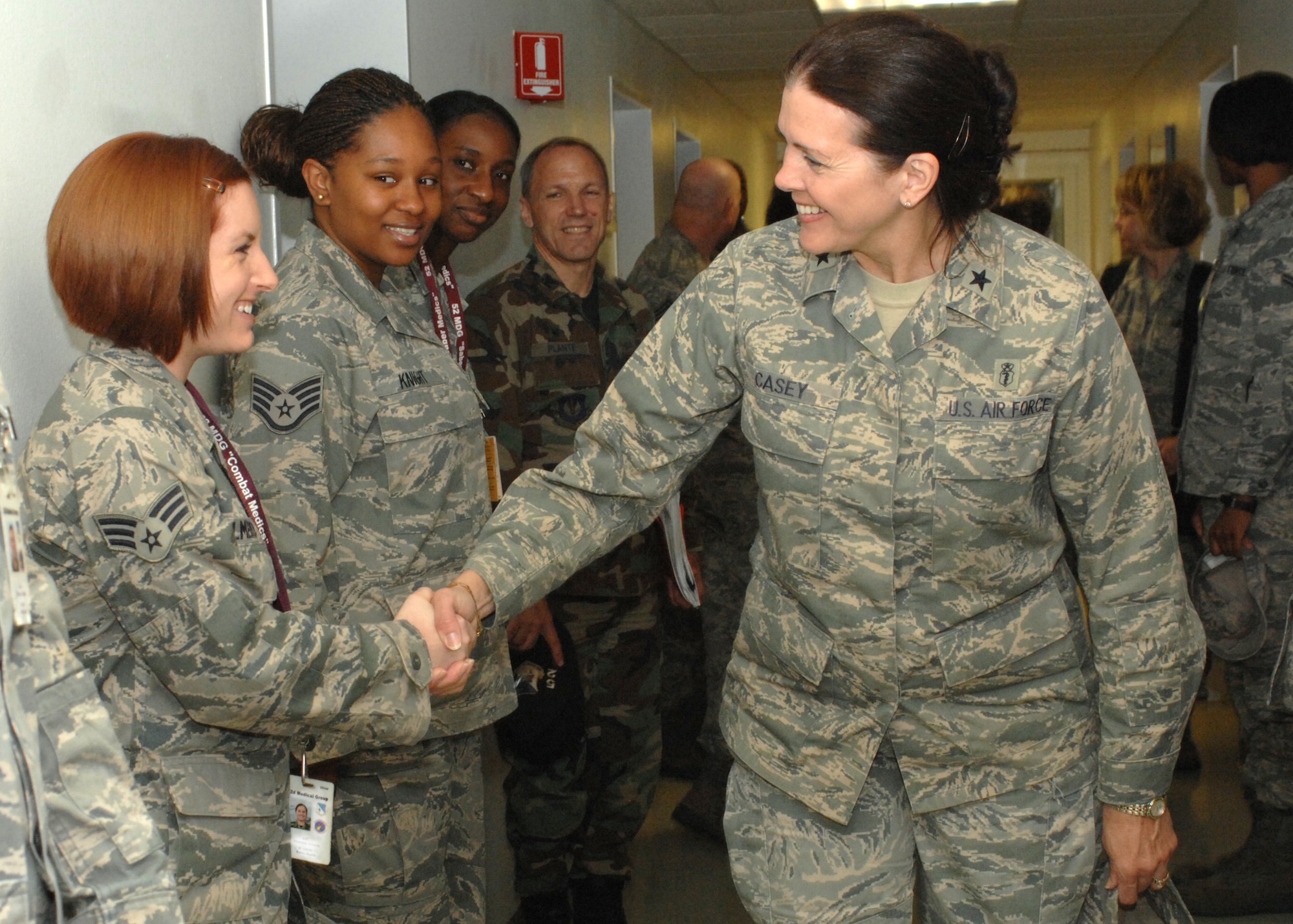 SPANGDAHLEM AIR BASE, Germany -- Brig. Gen. Theresa M. Casey, assistant surgeon general for modernization, Office of the Air Force Surgeon General, greets Senior Airman Sharron Almero as Airmen of the 52nd Medical Group look on May 27, 2009.  General Casey met with Airmen of the 52nd Medical Group and also received a briefing from the Public Health Office, which is where she began her career as a public health officer in 1982. (U.S. Air Force photo by Senior Airman Jenifer H. Calhoun)