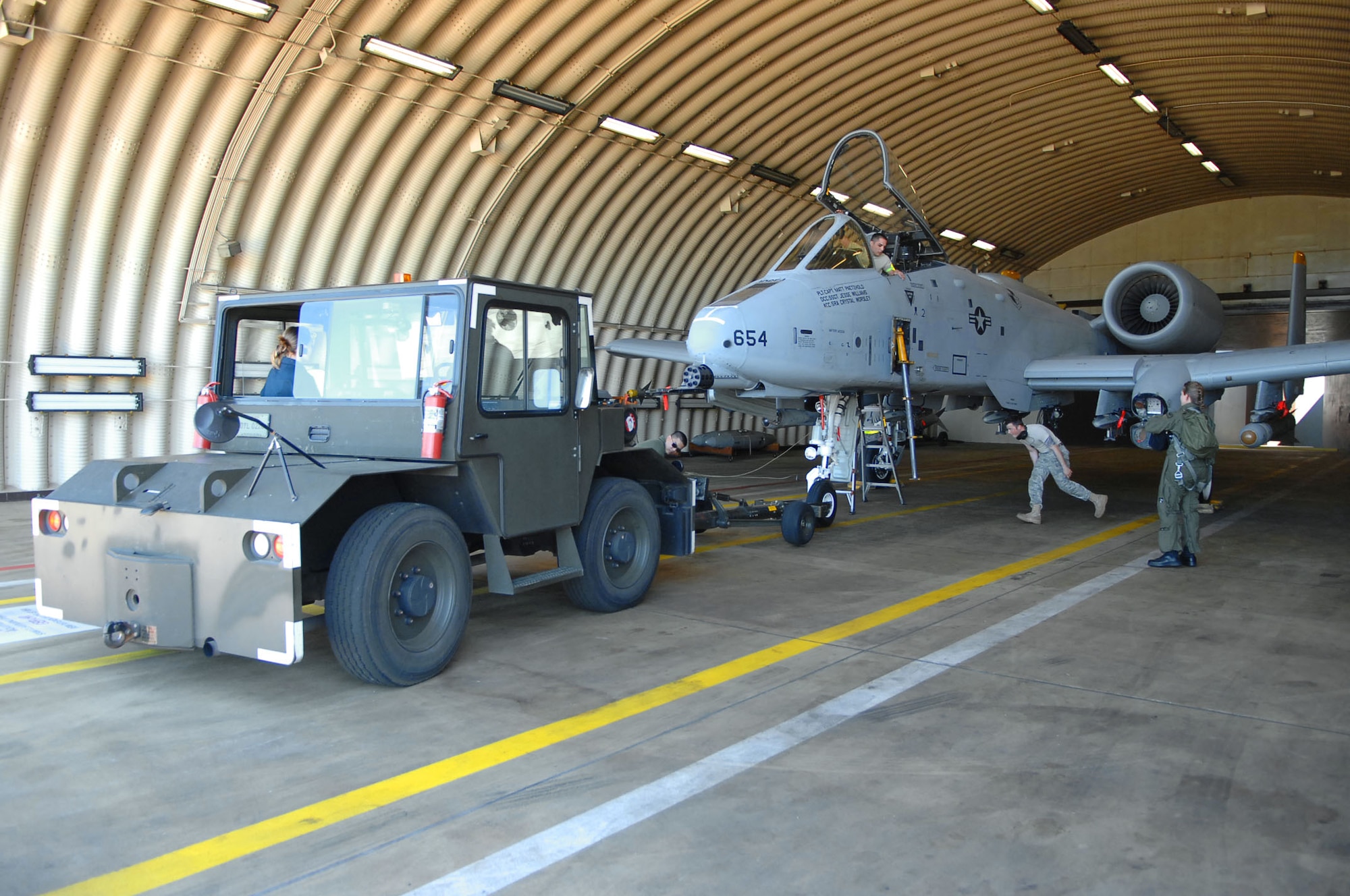 SPANGDAHLEM AIR BASE, Germany -- Members of the 52nd Aircraft Maintenance Squadron and 81st Fighter Squadron push an A-10 Warthog into a hardened aircraft shelter May 23, 2009.  A few of Spangdahlem Air Base's A-10 Warthogs performed a Memorial Day flyover at the Luxembourg American Cemetary in Hamm, Luxembourg.  ( U.S. Air Force photo by Airman 1st Class Nicholas Wilson )