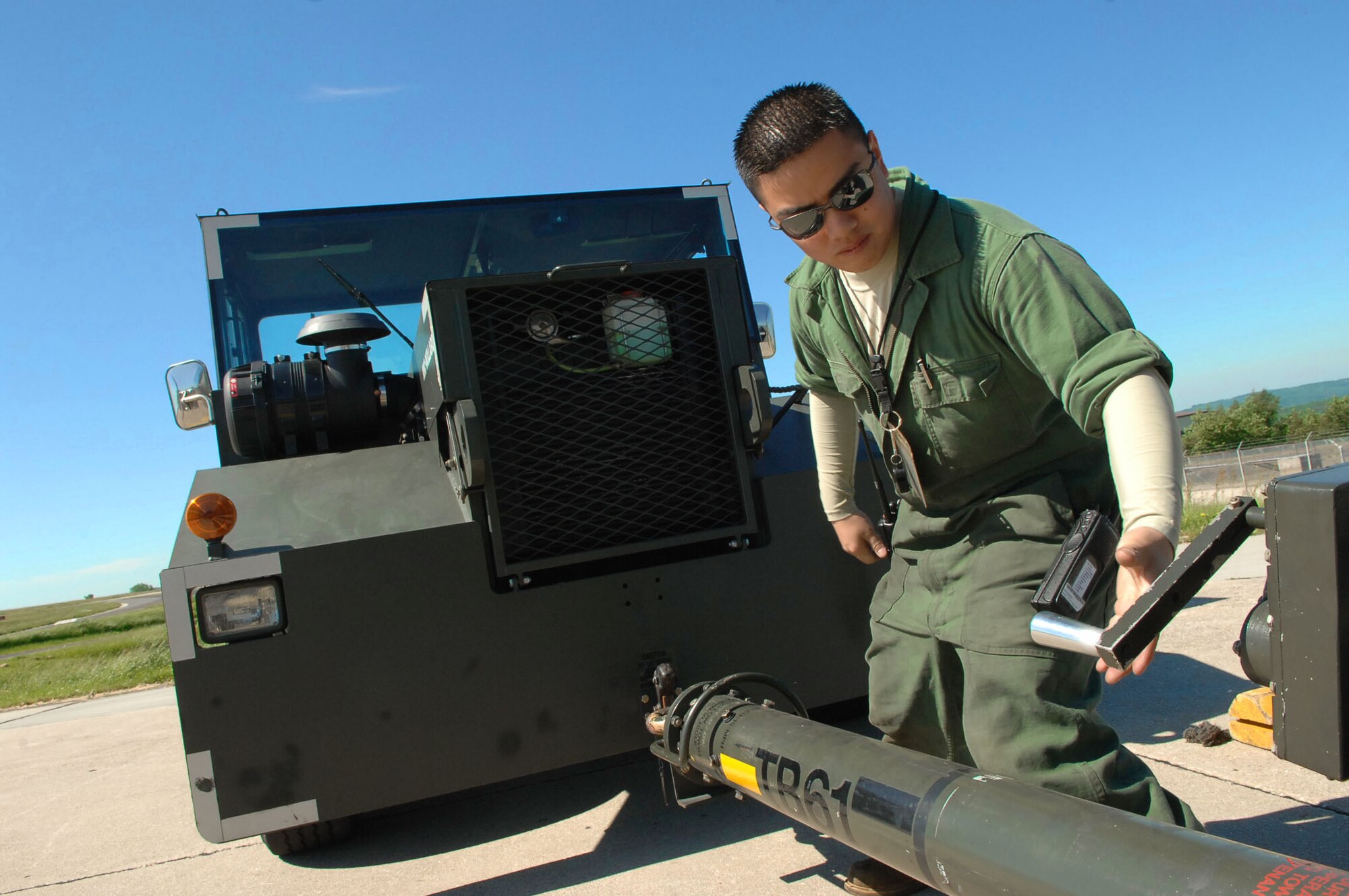 SPANGDAHLEM AIR BASE, Germany -- Staff Sgt. George Agustin, 81st Aircraft Maintenance Unit, connects an A-10 Warthog tow bar to a vehicle so it can push the aircraft into a hardened aircraft shelter May 23, 2009.  A few of Spangdahlem Air Base's A-10 Warthogs performed a Memorial Day flyover at the Luxembourg American Cemetary in Hamm, Luxembourg.  ( U.S. Air Force photo by Airman 1st Class Nicholas Wilson )