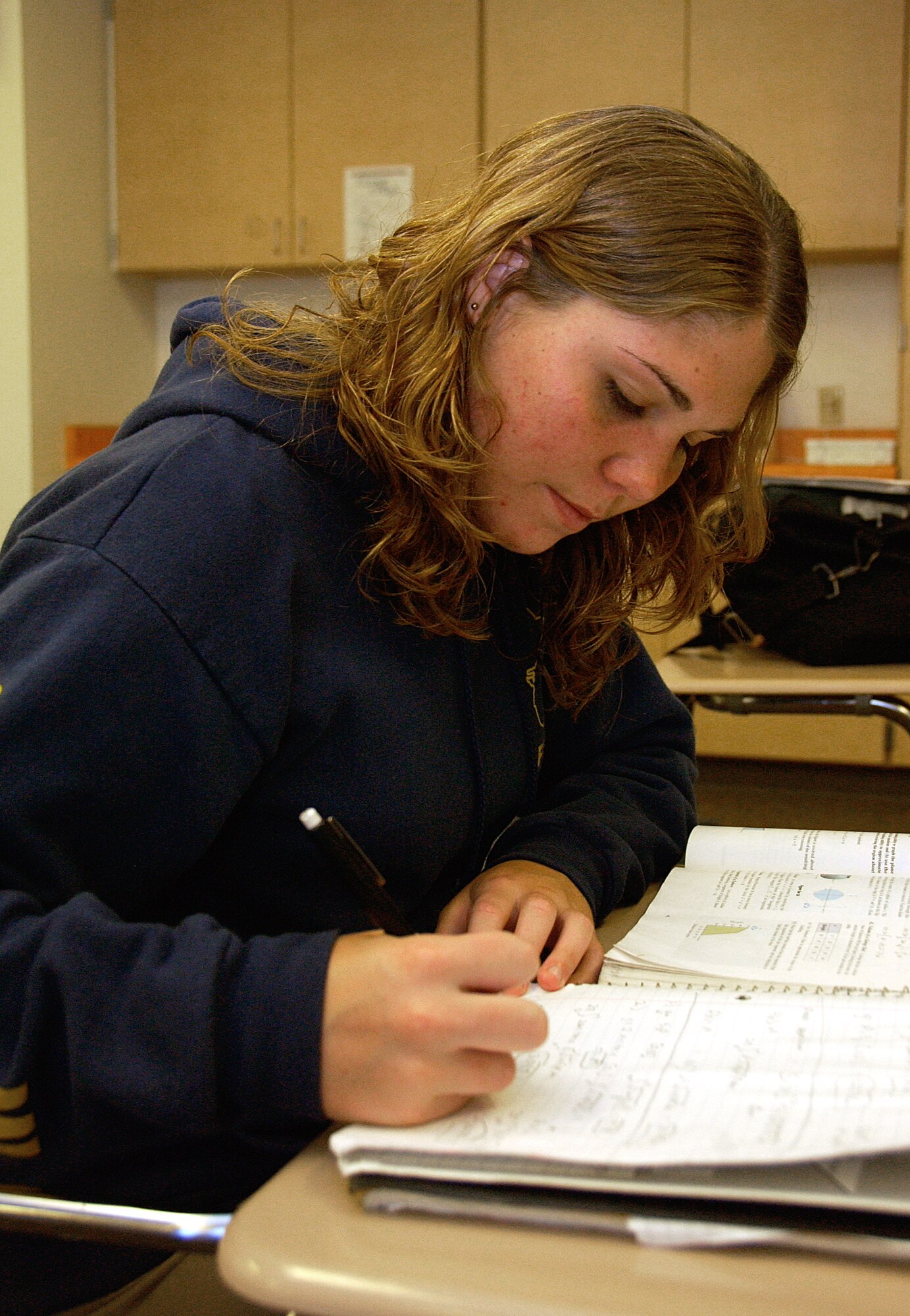 ANDERSEN AIR FORCE BASE, Guam -- Auriaunna Fry, daughter of Lt. Rob Fry, Helicopter Sea Combat Two Five Squadron aircraft intermediate-maintenance department officer and student of Guam High School, catches up on her Calculus classwork during a seminar class May 27. Auriaunna was recently appointed to Air Force Academy Preparatory School. An Air Force Academy Preparatory School appointment is equivalent to a full-ride scholarship of $40,000, providing free room and board, food, tuition, learning materials and $929 per month for the applicant to use at their discretion. (U.S. Air Force photo by Airman Carissa Wolff)      