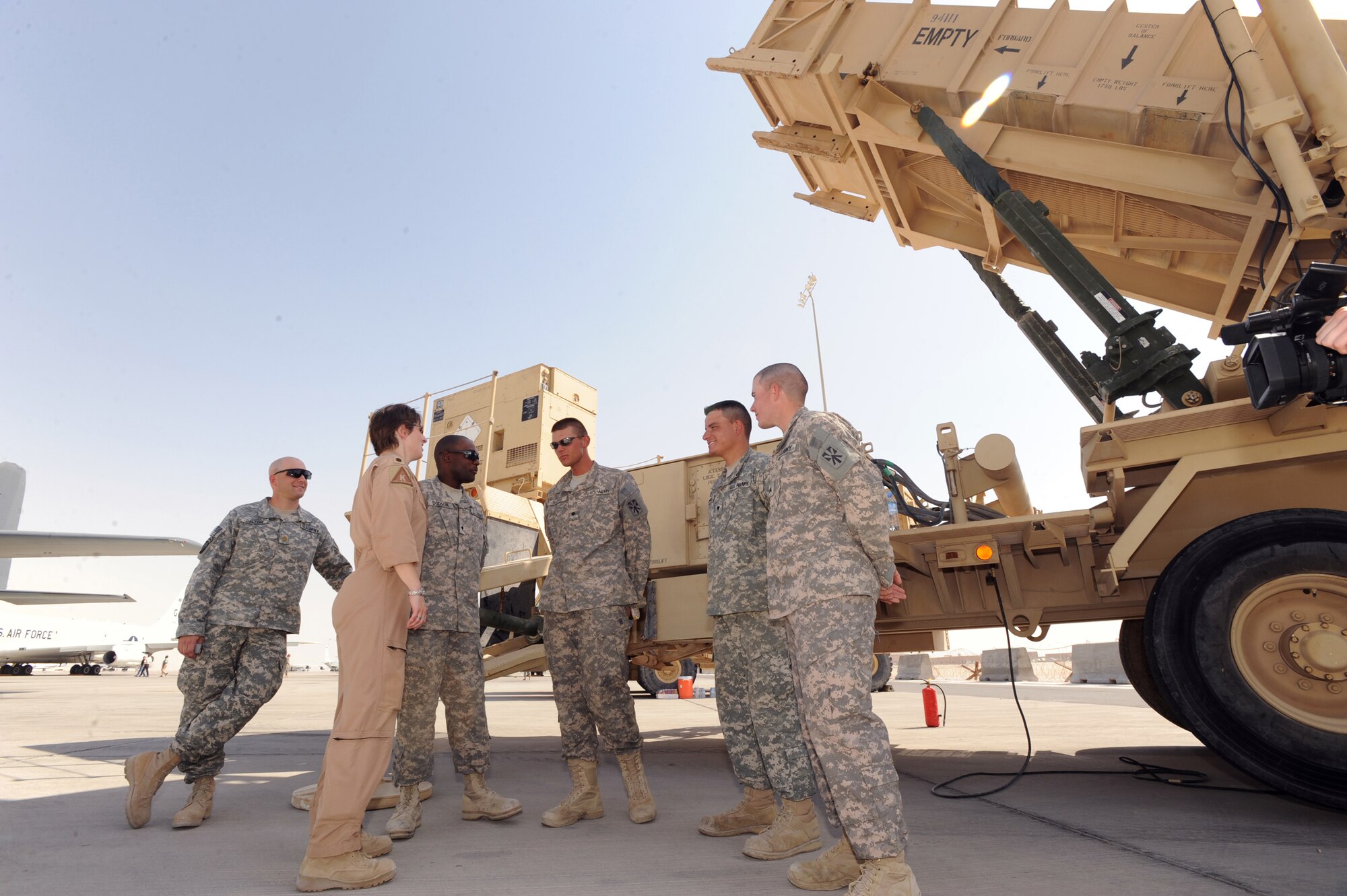 Air Force Major Kimberly "Crusher" Purdon, executive officer for the 379th Air Expeditionary Wing, talks with United States Army personnel about the capabilities and mission of the Patriot Air Missile Defense System during Flightline Fest, May 29, 2009, in an undisclosed location in Southwest Asia.  The 379th Air Expeditionary Wing hosted the half day event which gave base personnel the chance to look at static aircraft displays and other equipment up close, all without interrupting the mission of providing combat airpower throughout the U.S. Central Command's area of responsibility. Major Purdon is native to Lexington, Ky. and is deployed from Dyess Air Force Base, Texas. All personnel are deployed in support of Operations Iraqi and Enduring Freedom and Combined Joint Task Force - Horn of Africa.  (U.S. Air Force Photo by Staff Sgt. Joshua Garcia/released) 