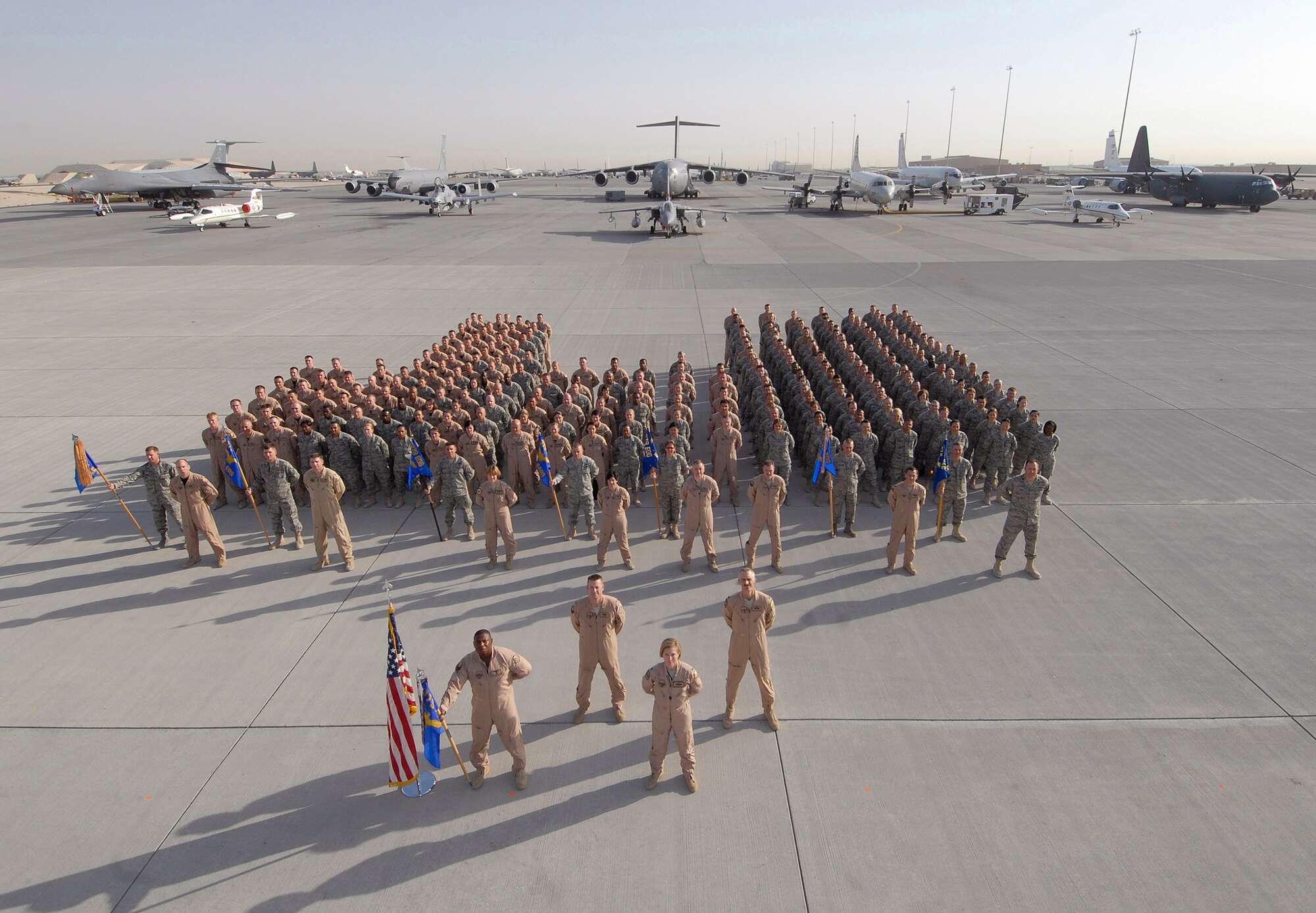 Members of the 379th Expeditionary Operations Group (EOG) stand in a formation for a group photo before the opening of Flightline Fest, May 29, 2009, at an undisclosed location in Southwest Asia.  The 379th Air Expeditionary Wing hosted the half day event which gave base personnel the chance to look at static aircraft displays and other equipment up close, all without interrupting the mission of providing combat airpower throughout the U.S. Central Command's area of responsibility.  The 379th EOG is deployed here in support of Operations Iraqi and Enduring Freedom and Combined Joint Task Force-Horn of Africa.  (U.S. Air Force photo/Senior Airman Andrew Satran/released)