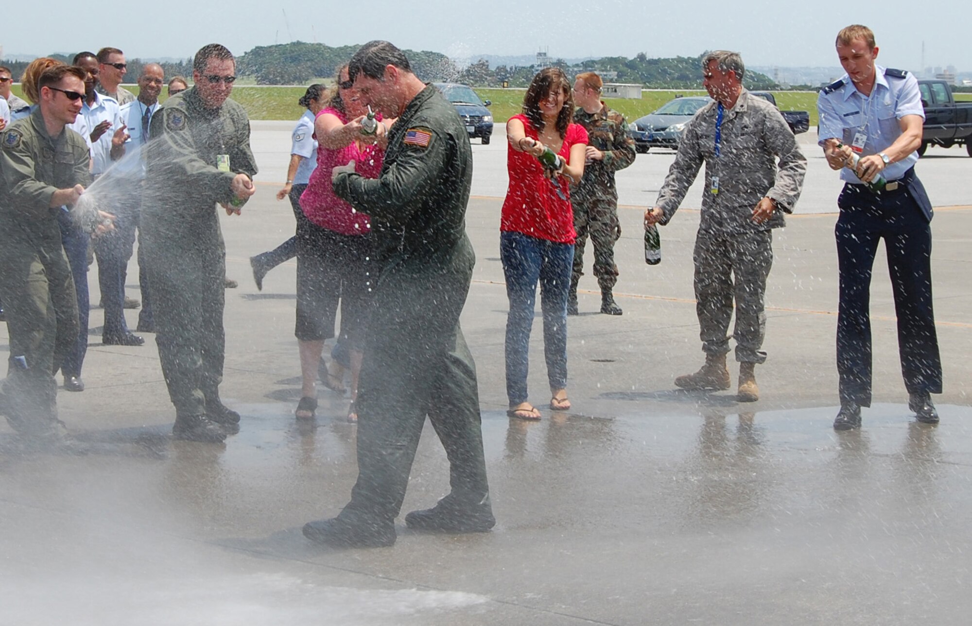 KADENA AIR BASE, Japan -- Col. David Mullins, the 353rd Special Operations Group commander, is sprayed down by members of the group and his family here June 1 after his final flight before moving on to his next assignment. The colonel flew in both a MC-130H Combat Talon II and MC-130P Combat Shadow for his final flight. (U.S. Air Force photo by James D'Angina) 