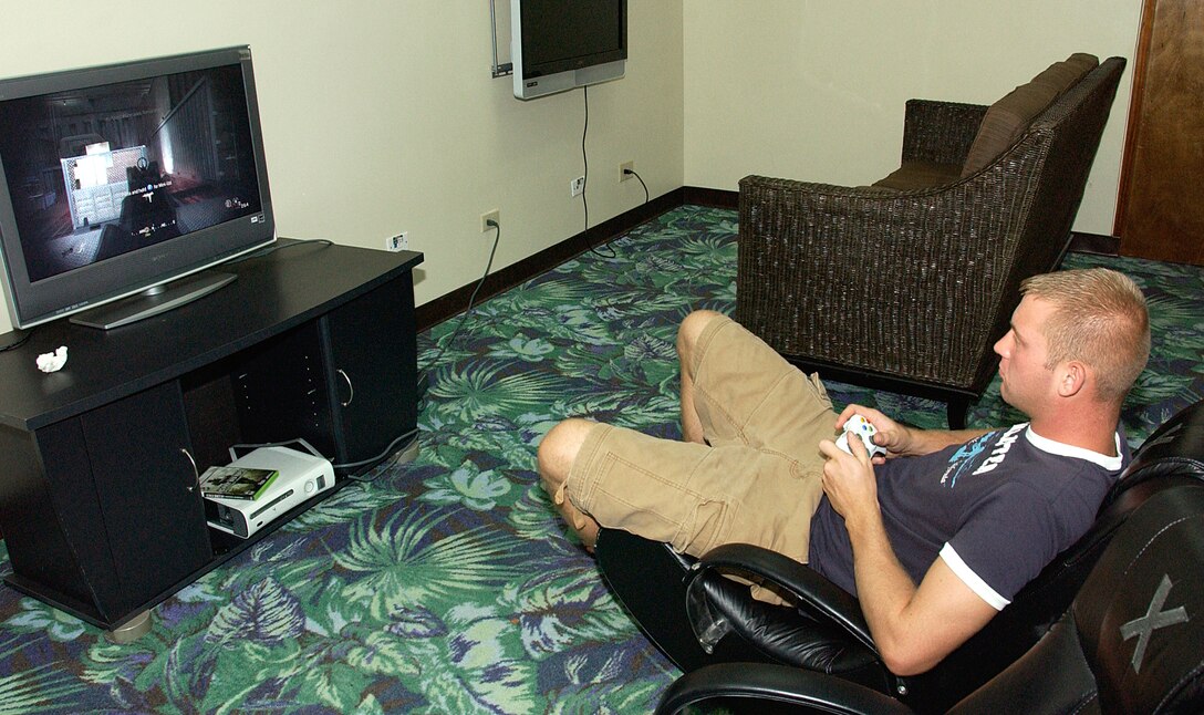 ANDERSEN AIR FORCE BASE, Guam -- Staff Sgt. Matt Close, 36th Munitions Squadron deployed conventional crew chief, uses his down time to relax in the HotSpot's gaming area May 28. The HotSpot offer nearly a dozen gaming stations with state-of-the-art video game consoles with a current selection of games available for checkout at the help desk. (U.S. Air Force photo by Airman Carissa Wolff)