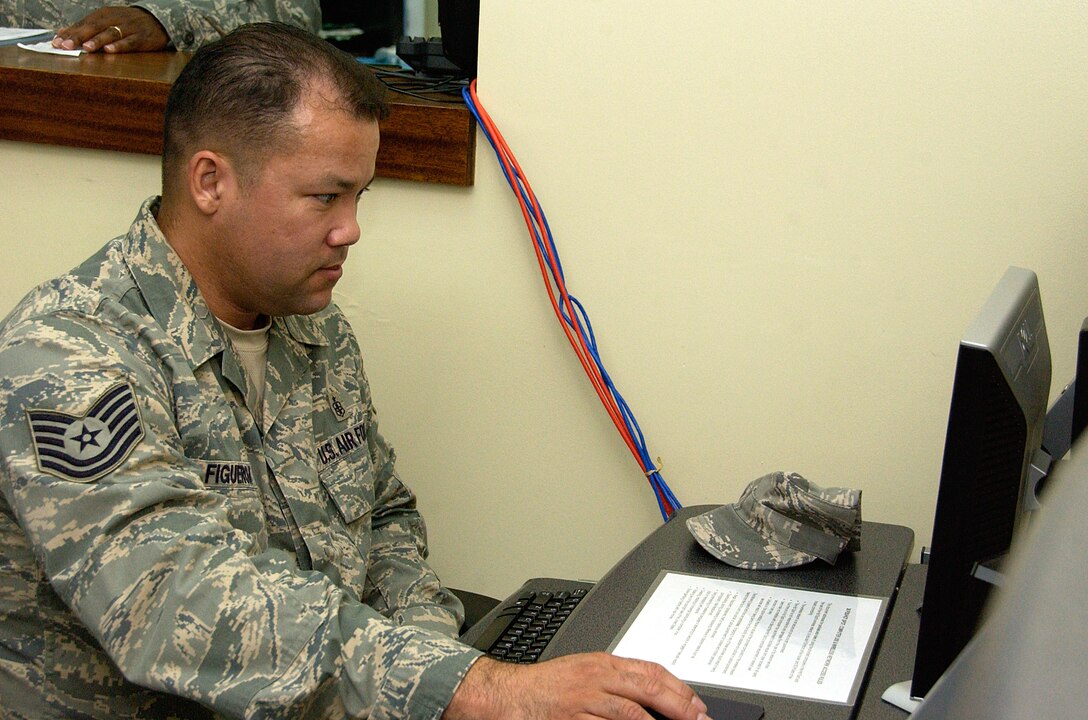 ANDERSEN AIR FORCE BASE, Guam -- Tech. Sgt. Francisco Figueroa, 36th Medical Support Squadron medical laboratory craftsman, takes a moment to check his email at the HotSpot May 28. The HotSpot offers more than half a dozen workstations with internet access and wireless internet capabilities throughout the facility. (U.S. Air Force photo by Airman Carissa Wolff)