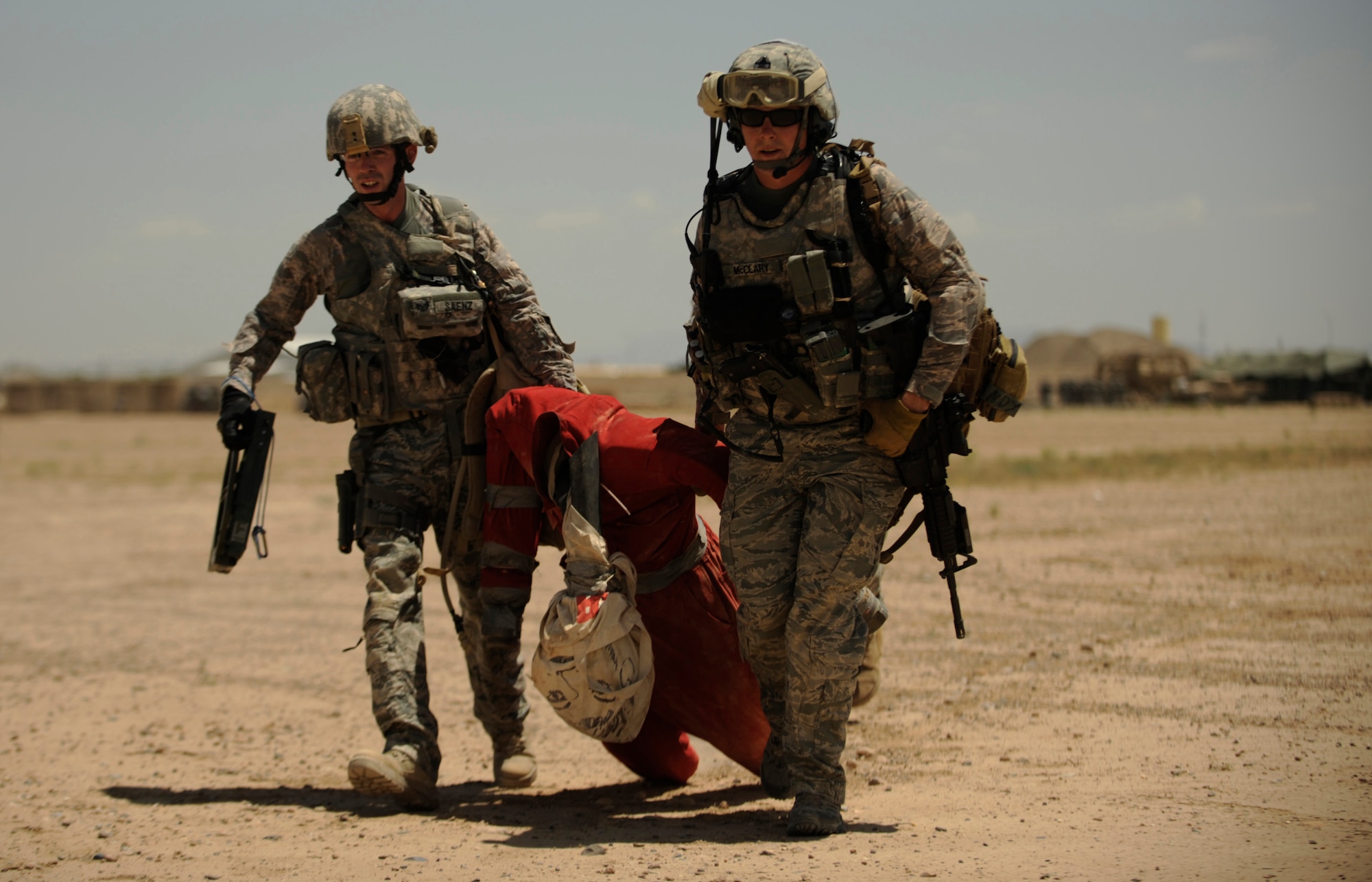 U.S. Air Force Staff Sgts. Ryan McCleary and Scott Saenz, both Explosive Ordinance Disposal technicians, 755th Explosive Ordinance Disposal, drag a simulated injured person from an IED site during joint explosive ordinance training at Kandahar Airfield, Afghanistan, on May 5, 2009, in support of Operation Enduring Freedom.  (U.S. Air Force photo by Staff Sgt. James L. Harper Jr.)