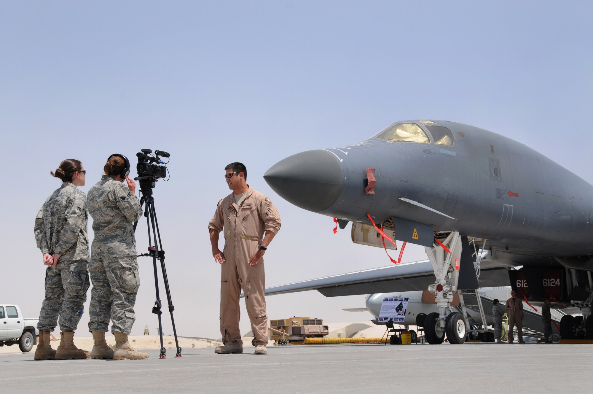 Captain James Dykas, a B-1B Lancer pilot with the 9th Expeditionary Bomb Squadron is interviewed by Airman 1st Class Jennifer Herring and Senior Airman Katerina Slivinske from the 379th Air Expeditionary Wing Public Affairs office during Flightline Fest, May 29, 2009, in an undisclosed location in Southwest Asia.  The 379th Air Expeditionary Wing hosted the half day event which gave base personnel the chance to look at static aircraft displays and other equipment up close, all without interrupting the mission of providing combat airpower throughout the U.S. Central Command's area of responsibility.  Airman Herring and Airman Slivinske are both radio and television broadcasters.  Airman Herring is from Savannah, Ga. and is deployed from Kadena Air Base, Japan.  Airman Slivinske is from Ventura, Calif. and is deployed from Holloman Air Force Base, N.M.  Capt Dykas is from Niceville, Fla. and is deployed from Dyess Air Force Base, Texas.  All are deployed in support of Operations Iraqi and Enduring Freedom and Combined Joint Task Force-Horn of Africa. (U.S. Air Force photo by Senior Master Sgt. Brad Fallin/released)