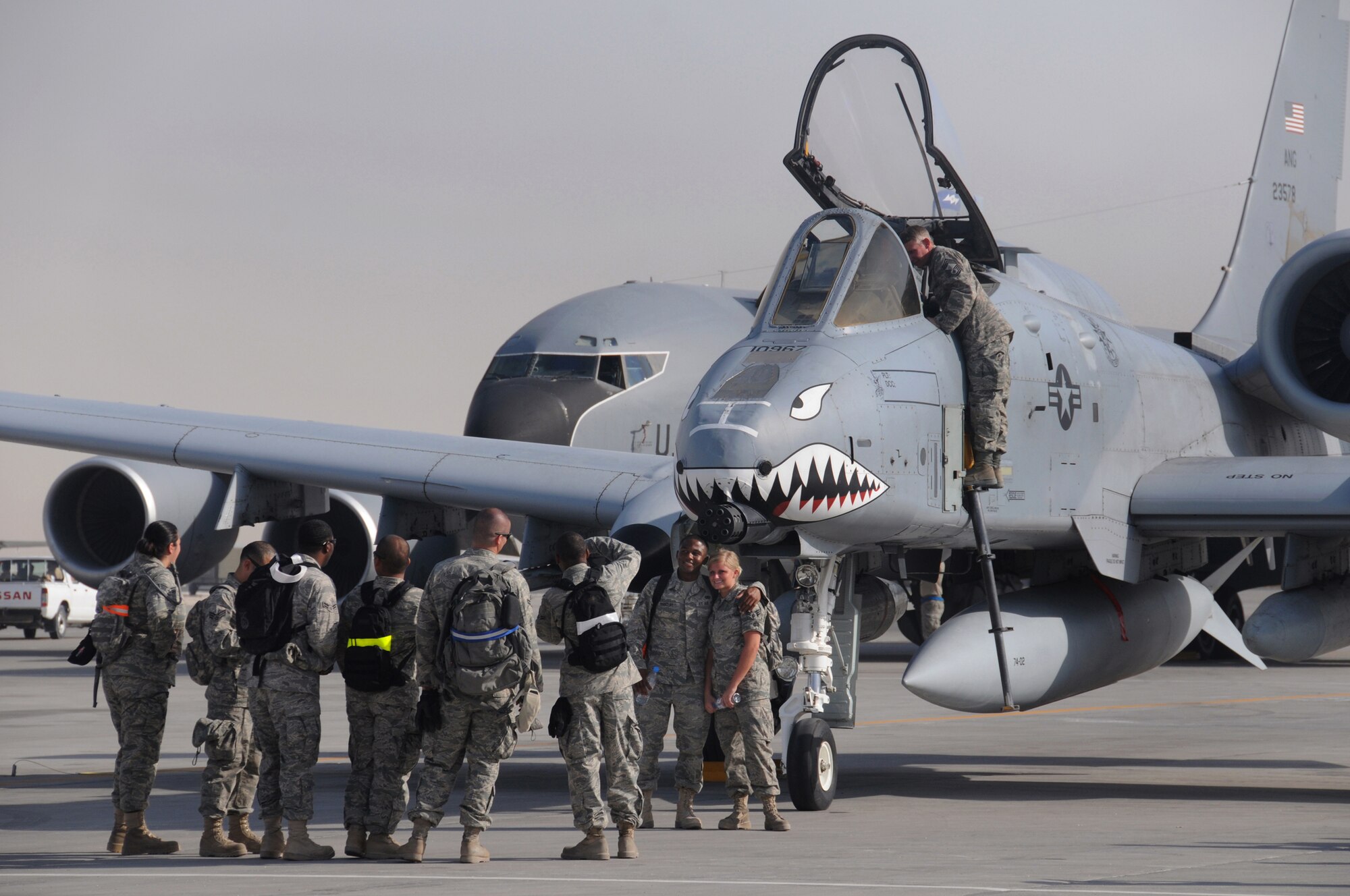 Airmen take advantage of the opportunity to visit the flightline and photograph an A-10C Thunderbolt II close air support aircraft at Flightline Fest, May 29, 2009, in an undisclosed location in Southwest Asia.  The 379th Air Expeditionary Wing hosted the half day event which gave base personnel the chance to look at static aircraft displays and other equipment up close, all without interrupting the mission of providing combat airpower throughout the U.S. Central Command's area of responsibility.  The 379th Air Expeditionary Wing operates in support of Operations Iraqi and Enduring Freedom and Combined Joint Task Force-Horn of Africa.  (U.S. Air Force photo by Senior Master Sgt. Brad Fallin/released)