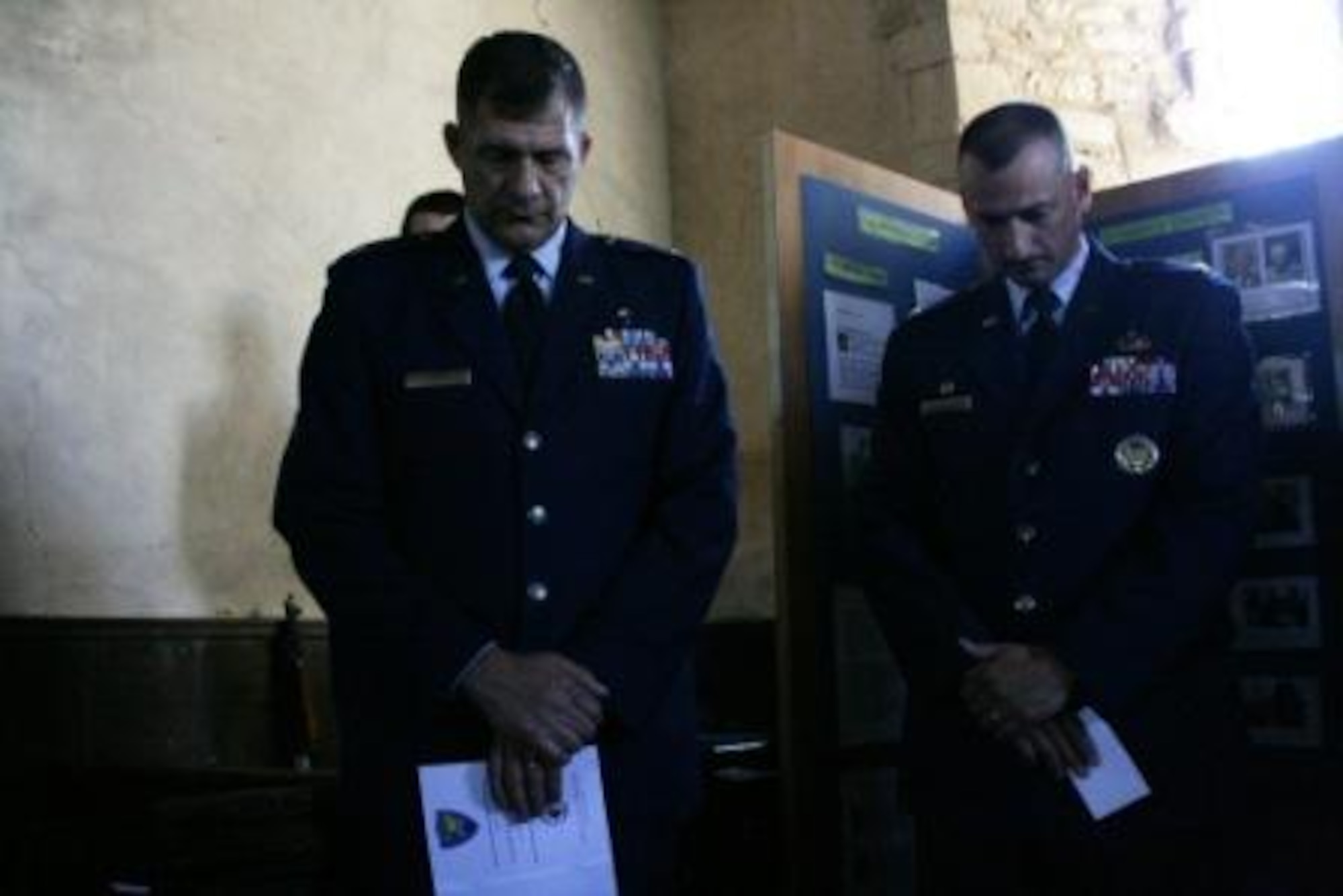 Chaplain (Lt. Col.) Walter Bean and Col. Timothy Cashdollar observe a moment of silence during a memorial dedication service at St. Mary's Church, Yelden, Bedfordshire. The service honored U.S. military personnel who died March 24, 1944 when a B-17 Flying Fortress crashed upon takeoff from RAF Cheveston. The crash killed 11 aircrew members, eight military personnel on the ground and two children from the village. 