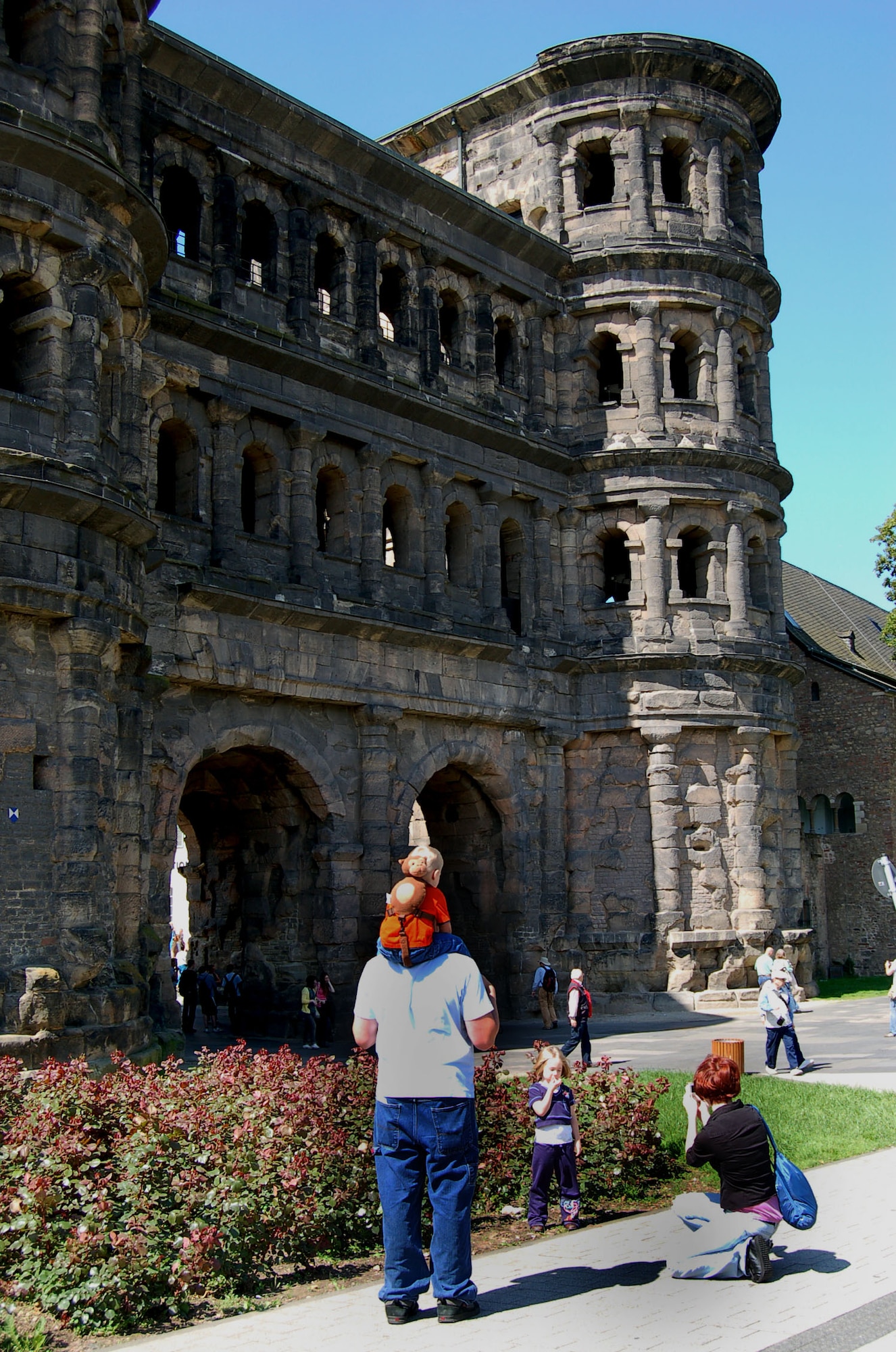 SPANGDAHLEM AIR BASE, Germany -- Senior Airman Jeremy Halton, 52nd Logistics Readiness Squadron; his wife, Christina; and their children, Audrey, 4, and Logan, 3, stand at the base of the Porta Nigra in Trier May 22, 2009 during the weekly trip to the town sponsored by the Airman & Family Readiness Center. (U.S. Air Force photo by Senior Airman Kali L. Gradishar)