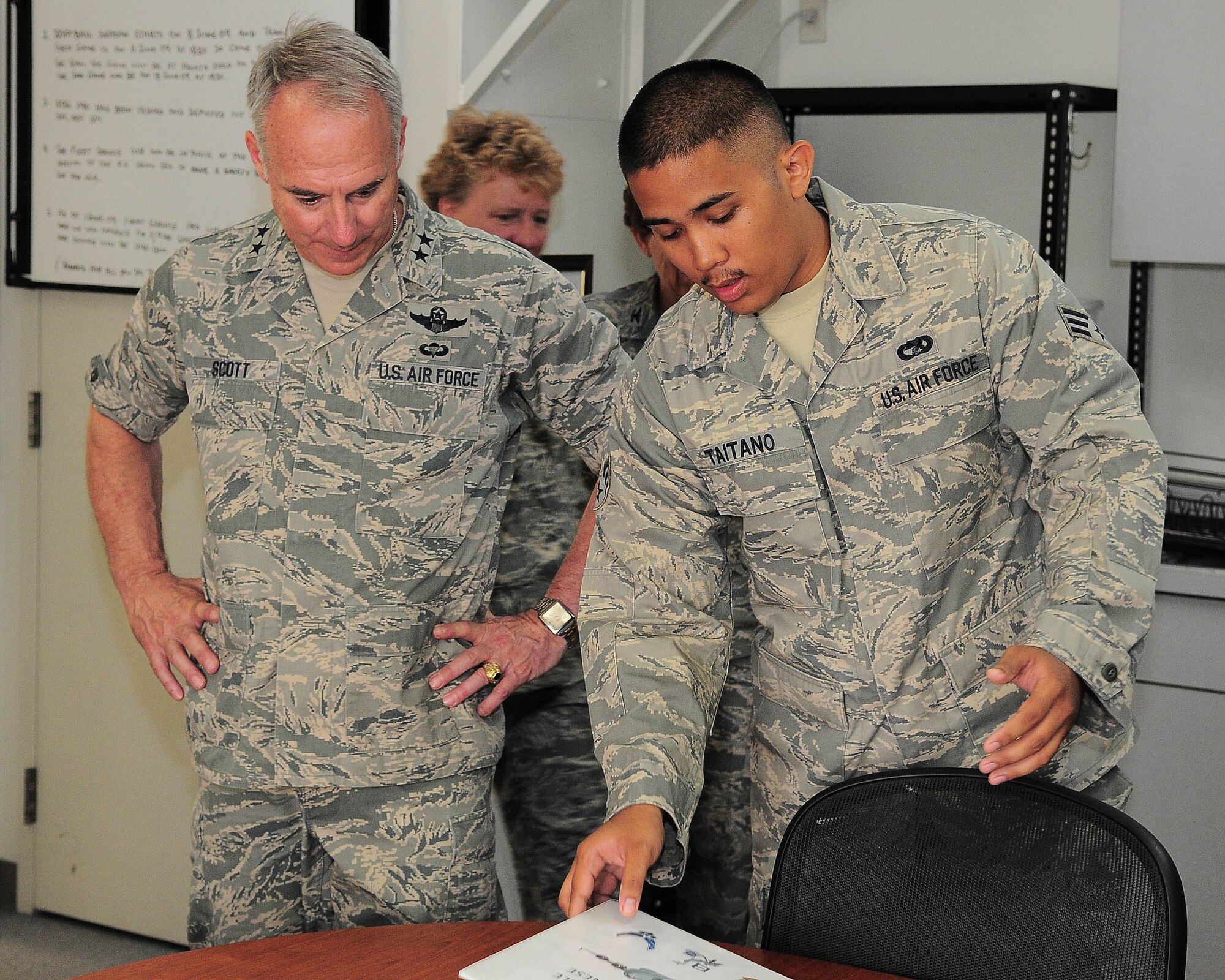 YOKOTA AIR BASE, Japan -- Senior Airman Ryan Taitano, 730th Air Mobility Squadron, briefs Maj. Gen. Winfield W. Scott III, 18th Air Force commander, during a tour of Yokota Air Base May 31. General Scott was here looking for innovative ideas to revamp the mobility system throughout the Air Force. (U.S. Air Force photo/Airman 1st Class Michael Dillon)