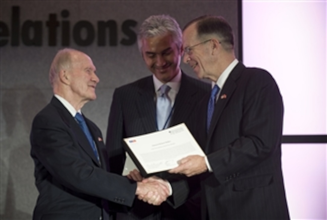 Chairman of the Joint Chiefs of Staff Adm. Mike Mullen (right), U.S. Navy, is presented the American-Turkish Council Distinguished Defense Award by the Chairman of the Board of the American-Turkish Council retired Lt. Gen. Brent Scowcroft (left) and Chairman of the Turkish U.S. Business Council Haluk Diner at the 28th Annual Conference on U.S.-Turkish Relations at the Gaylord National Resort and Conference Center, National Harbor, Md., on June 1, 2009.  