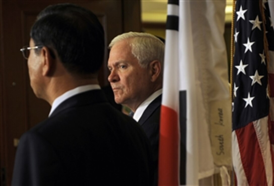 Secretary of Defense Robert M. Gates listens to a translation after the first trilateral meeting with Japan and South Korea on the sidelines of the Shangri-La Asia Security Summit on May 30, 2009 in Singapore.  