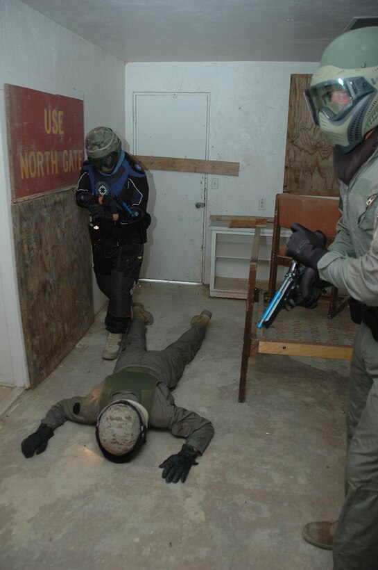 Officer Jose Valencia, left, and Lance Cpl. Malcolm Aranda, military policeman, secure a room after neutralizing an enemy shooter during a school shooting simulation in a training house at the Marine Corps Air Station in Yuma, Ariz., June 2, 2009. The exercise, which included the use of nonlethal live ammunition, was designed to improve the officers' tactics and confidence in shootouts.