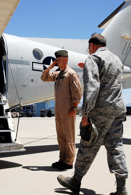 Sgt. Garret Temple, UC-12B crew chief from the Marine Corps Air Station in Yuma, Ariz., salutes Lt. Gen. Charles Stenner, the chief of the Air Force Reserve, before boarding the aircraft in Tuscon, Ariz., June 2, 2009. Temple, along with two pilots, flew Stenner to Salt Lake City. Since June 2008, the planes have flown approximately 1,150 hours for a total of 314 flights.(Photo by Cpl. Laura A. Mapes)