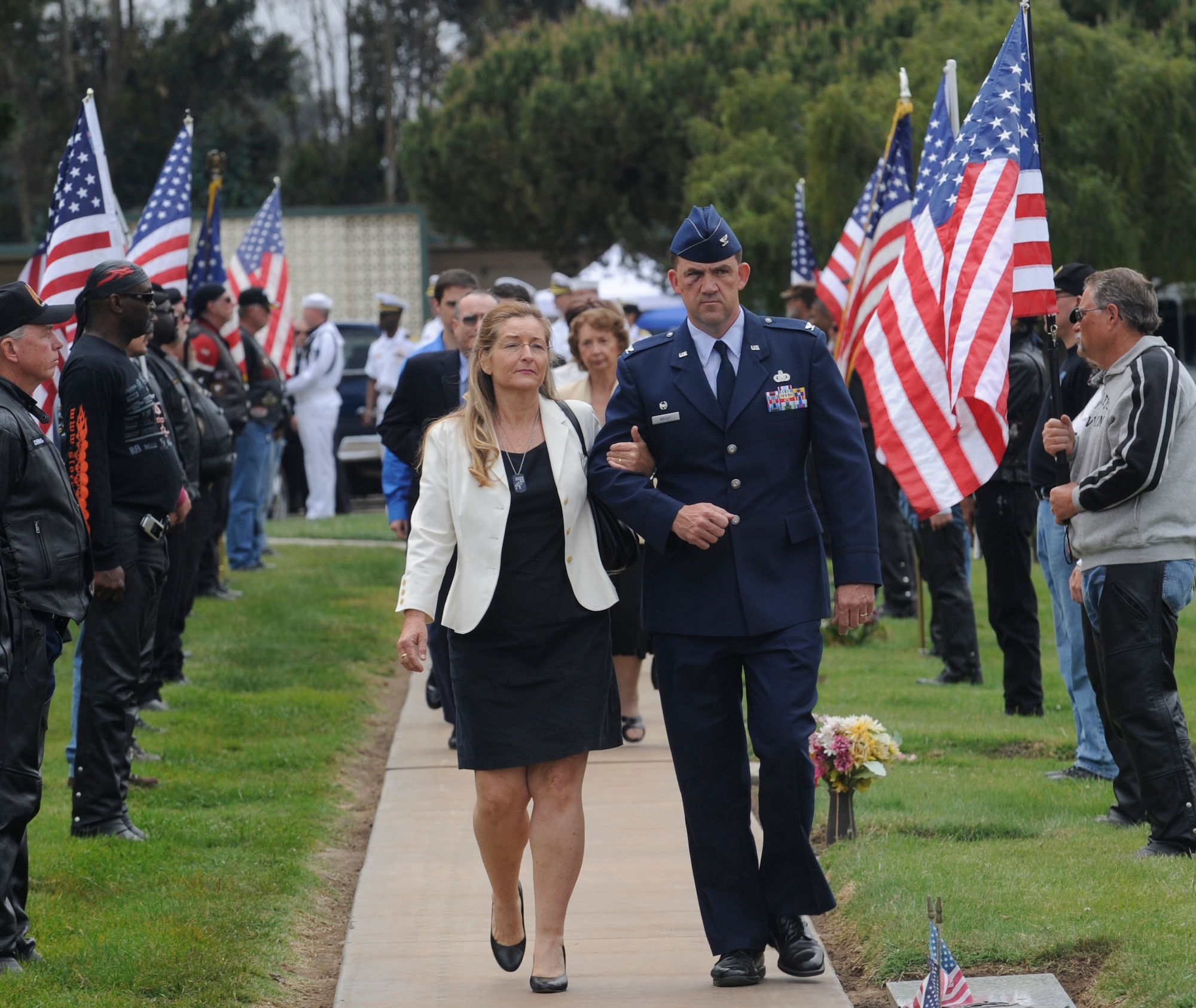 LOS OSOS, Calif.-- Cindi Wolfe, wife of Commander Duane Wolfe, is escorted by Col Richard Wright, 30th Mission Support Group commander, to the Los Osos Memorial Gardens June 2.  Commander Wolfe was killed by a roadside bomb outside of Fallujah, Iraq May 25. Commander Wolfe, a Naval Reservist, worked at Vandenberg as the civilian deputy for the 30th Mission Support Group. (U.S. Air Force Photo/ Senior Airman Stephanie Longoria)