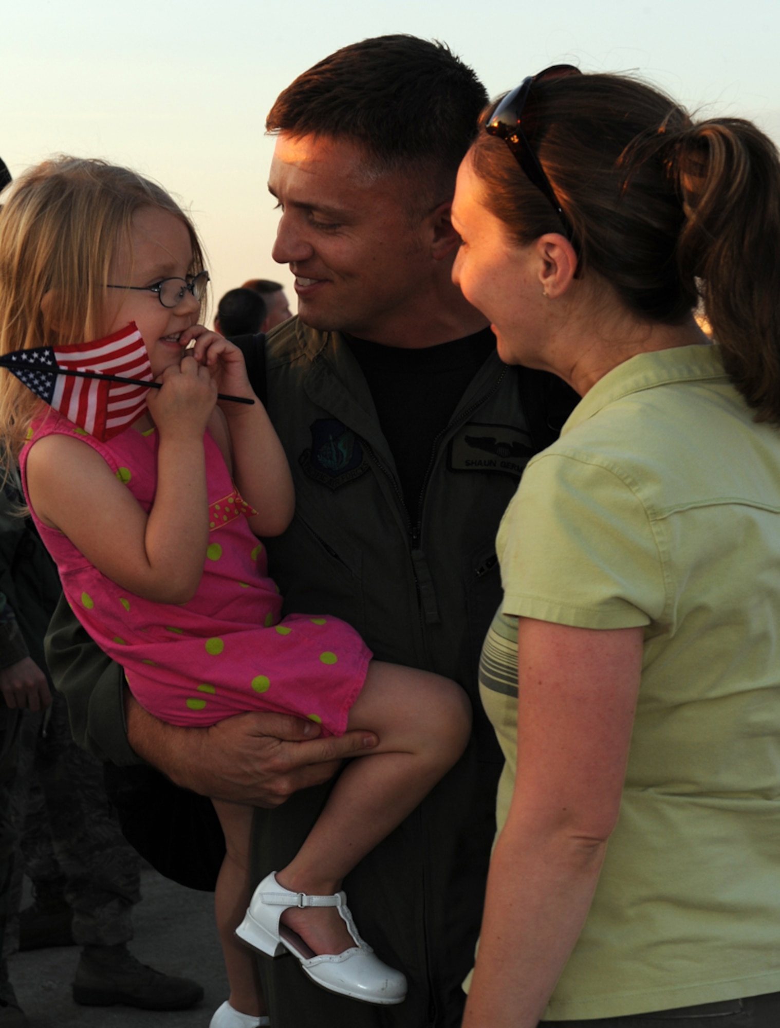 WHITEMAN AIR FORCE BASE, Mo. – Capt. Shaun Germain, 13th Bomb Squadron, with his wife, Cat, holds his daughter, Hannah, 3, May 29 upon returning home from a recent deployment to Andersen Air Force Base, Guam. More than 250 members of Team Whiteman deployed to Guam February to support the continuous bomber presence in the Western Pacific Region. (U.S. Air Force photo/Airman 1st Class Carlin Leslie)