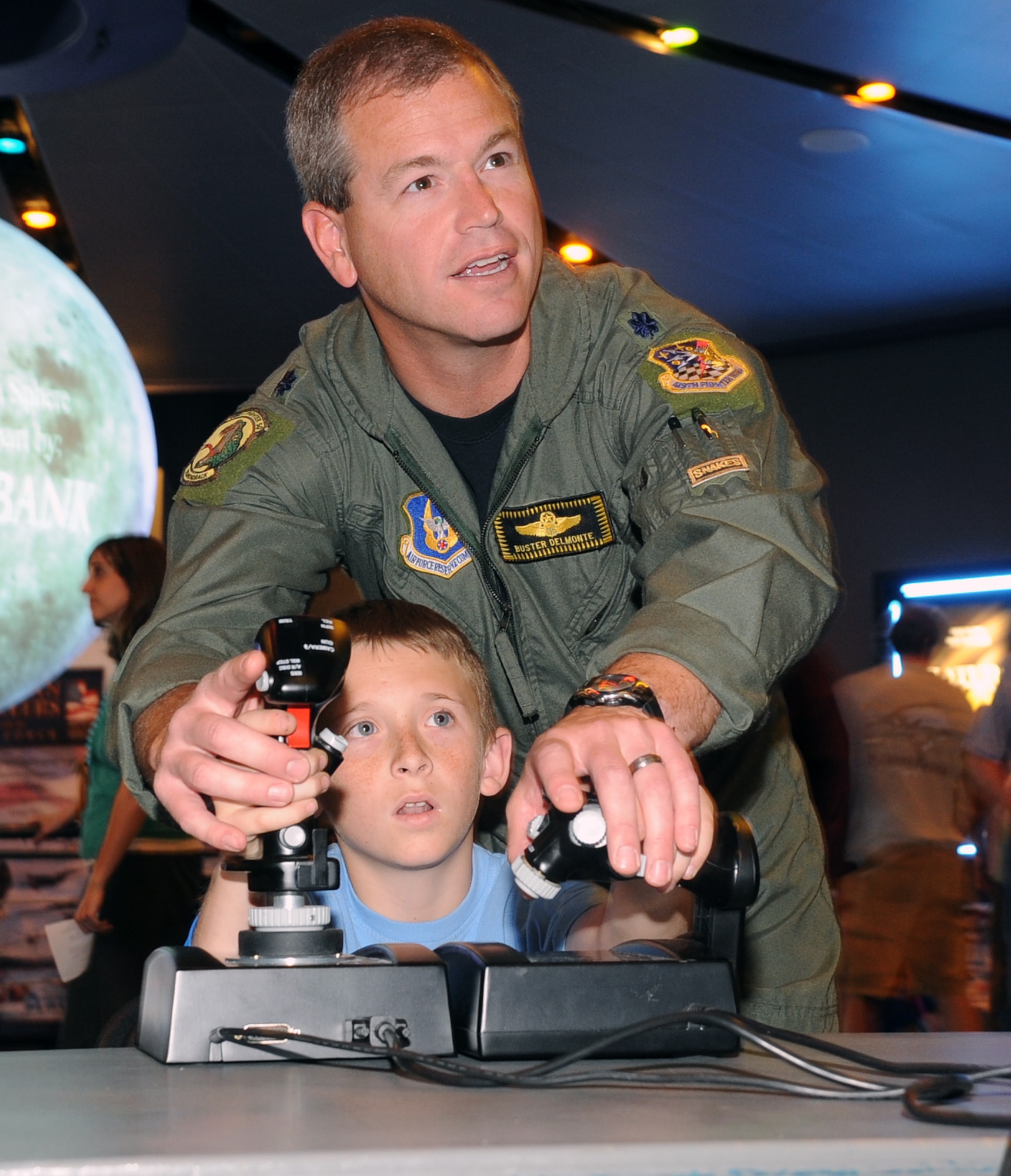 Pilot in training, Cooper Hirst of Ogden Utah, gets a little help with the
controls of a Flight Simulator from 466th Fighter Squadron pilot, Lt. Col.
Buster Delmonte, before the showing of the IMAX movie "Fighter Pilot:
Operation Red Flag" at the Clark Planetarium in Salt Lake City during Air
Force Week Salt Lake City on June 2. (U.S. Air Force photo by Alex R. Lloyd)
