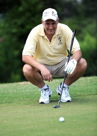 John Kenney lines up a putt on the 18th hole of the Wrenwoods Golf Course at Charleston AFB June 3. Wrenwoods Golf Course was designed by George Cobb in 1966. He also designed the Par 3 course at Augusta National Golf Club, Augusta, Ga., the home of the Masters Golf Tournament. Kenney is a member of the U.S. Coast Guard. (U.S. Air Force photo/Senior Airman Timothy Taylor)