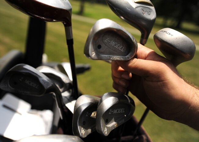 Jeremy Blanton selects a club to use on the fairway at the Wrenwoods Golf Course on Charleston AFB June 3. Wrenwoods is a Par 72 course open daily from 7 a.m. to dusk. Mr. Blanton is a Chief Petty Officer in the U.S. Coast Guard. (U.S. Air Force photo/Senior Airman Timothy Taylor)
