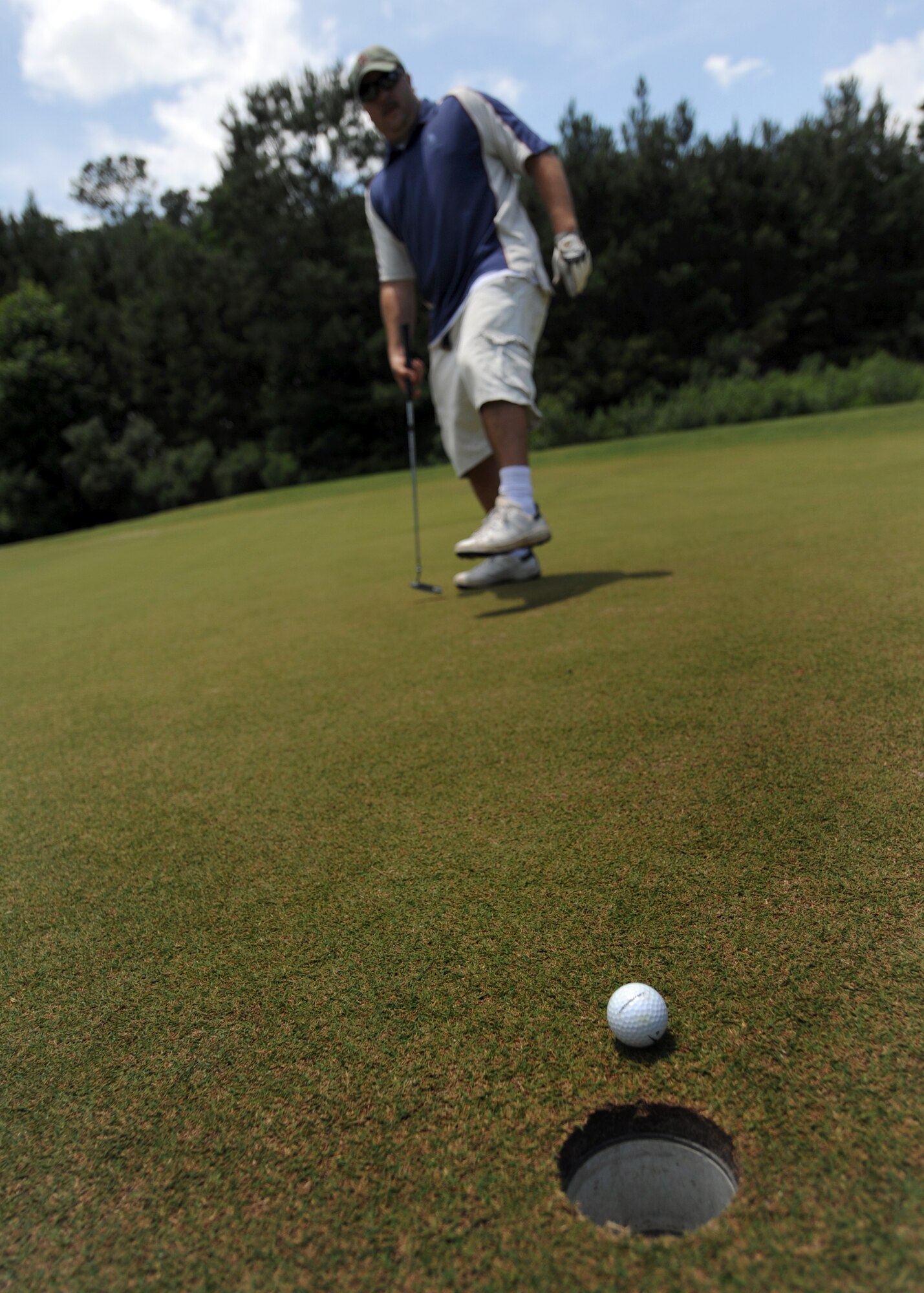 Jeremy Blanton taps in a 10-foot putt at the Wrenwoods Golf Course on Charleston AFB June 3. Wrenwoods Golf Course is a 72 Par course spread over 200 acres. Blanton is a member of the U.S. Coast Guard. (U.S. Air Force photo/Senior Airman Timothy Taylor)
