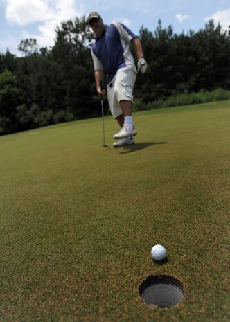 Jeremy Blanton taps in a 10-foot putt at the Wrenwoods Golf Course on Charleston AFB June 3. Wrenwoods Golf Course is a 72 Par course spread over 200 acres. Blanton is a member of the U.S. Coast Guard. (U.S. Air Force photo/Senior Airman Timothy Taylor)