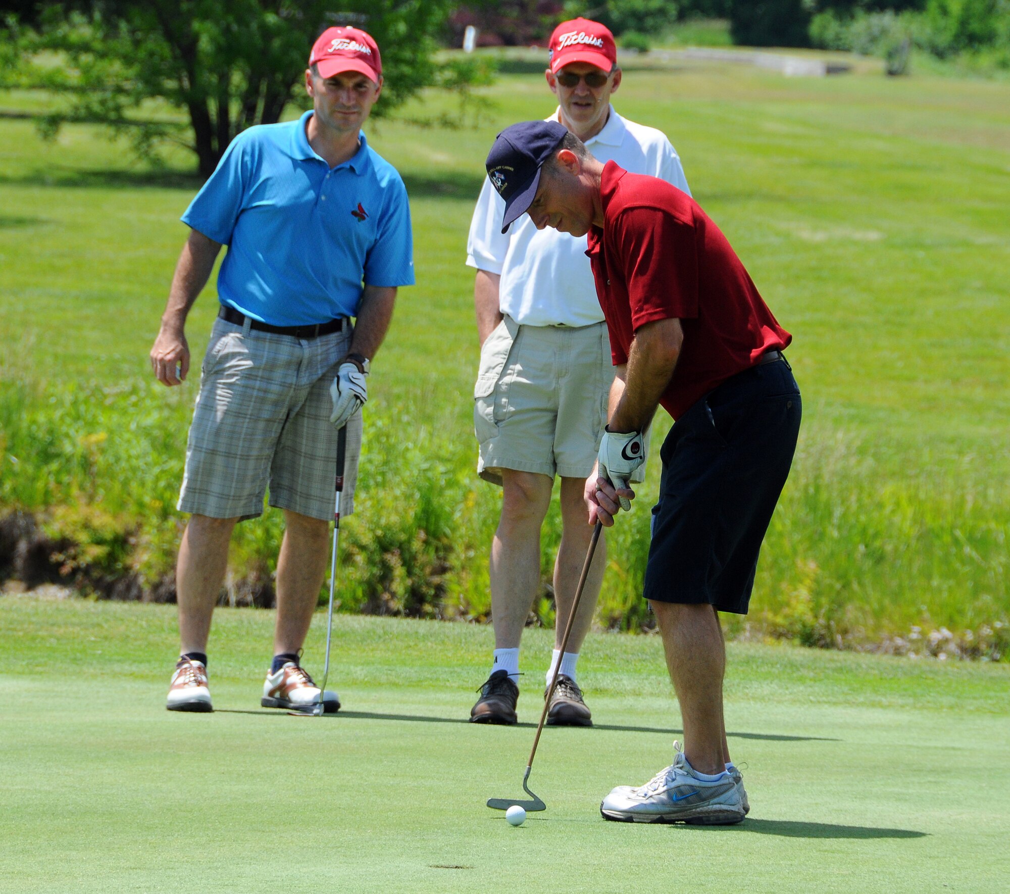 SCOTT AIR FORCE BASE, Ill. -- Jay Stocks, USTRANSCOM, attempts a putt May 21 during the Scott Marines Semper Fi Society Devil Dog Golf Invitational at Cardinal Creek. Watching Mr. Stocks are Lance Davidson, and Maj. Gen. William Johnson.  The three gentlemen are from U.S. Transportation Command. (U.S. Air Force photo/Bob Fehringer)