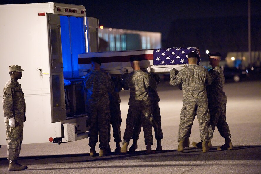 An Army carry team transfers the remains of Army Staff Sergeant Jeffrey Hall, of Huntsville, Ala., at Dover Air Force Base, Del., June 2. Staff Sergeant Hall was assigned to the 2nd Battalion, 87th Infantry Regiment, 3rd Brigade Combat Team, 10th Mountain Division (Light Infantry) Fort Drum, N.Y.
(U.S. Air Force Photo/Jason Minto)
 
