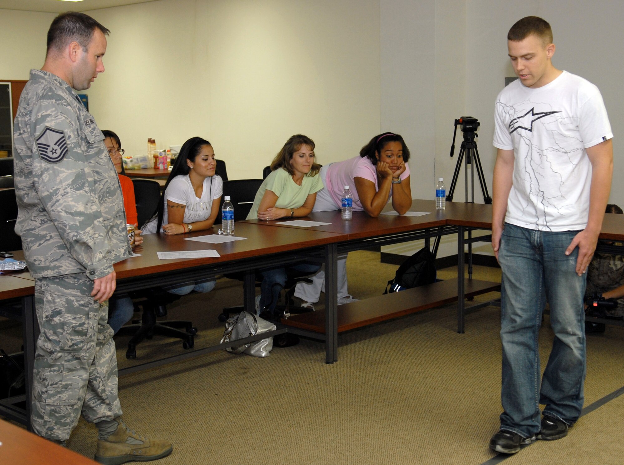 Master Sgt. Dan Delzingaro and Airman 1st Class Philip Sneed demonstrate standard sobriety test procedures for spouses during the civilian police academy course May 27 at Kadena Air Base, Japan. Sergeant Delzingaro and Airman Sneed are both members of the 18th Security Forces Squadron. (U.S. Air Force photo/Tech. Sgt. Angelique Perez) 