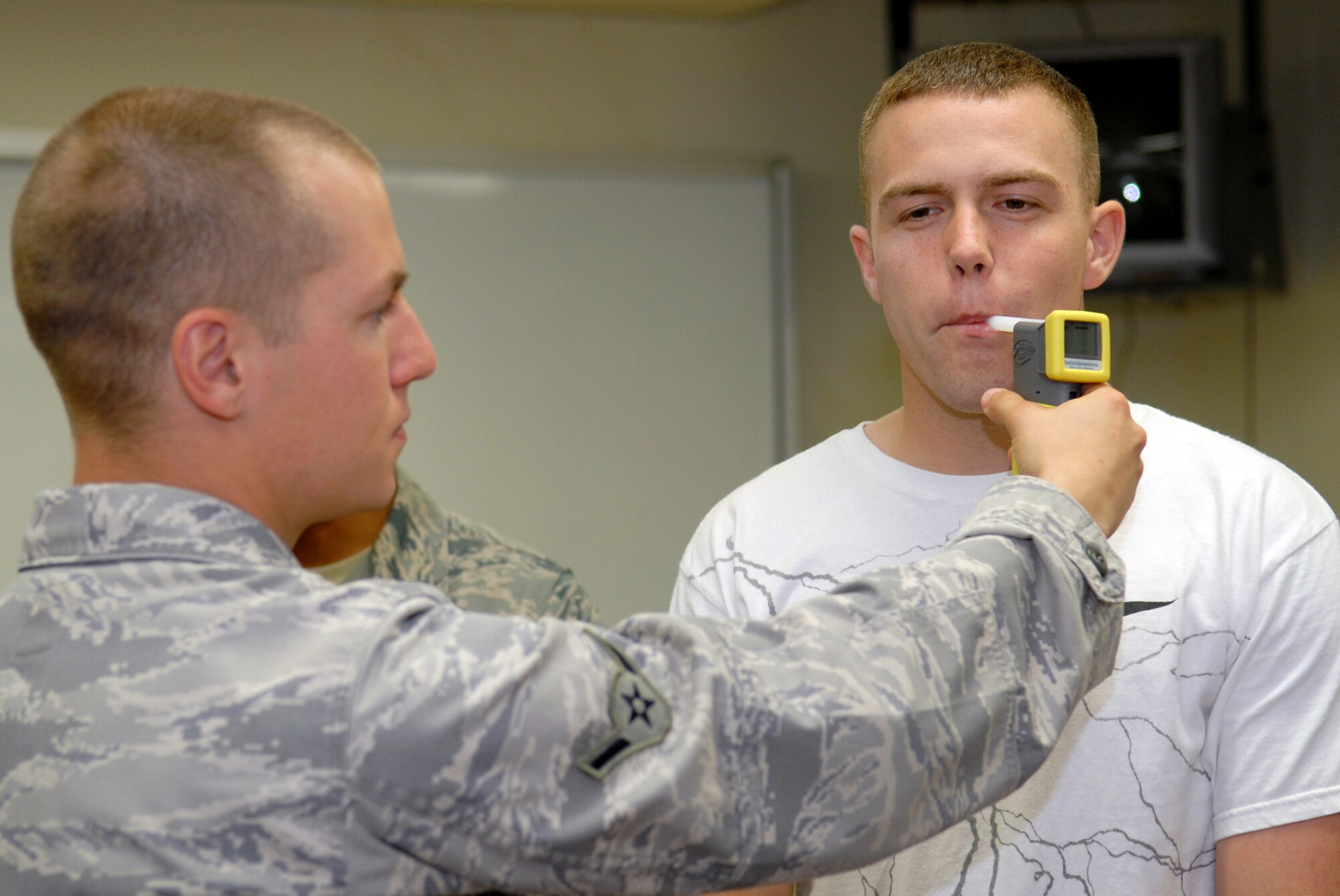 Airman 1st class Eric Barth and Airman 1st Class Philip Sneed demonstrate standard sobriety test procedures for spouses during the civilian police academy course May 27 at Kadena Air Base Japan. Airmen Barth and Sneed are both members of the 18th Security Forces Squadron. (U.S. Air Force photo/Tech. Sgt. Angelique Perez) 