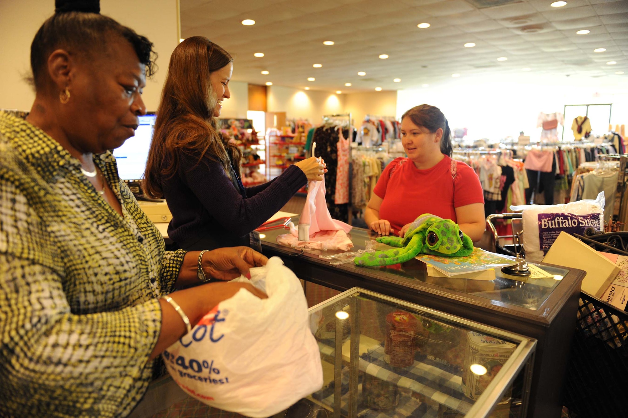 SHAW AIR FORCE BASE, S.C. -- Volunteers Catherine Harrison and Charlotte Teel help Debra Monahan check out after shopping at the base thrift store May 28, 2009. The base thrift store has many volunteers that help with daily operations for thrift store customers. (U.S. Air Force photo/Senior Airman Matt Davis)