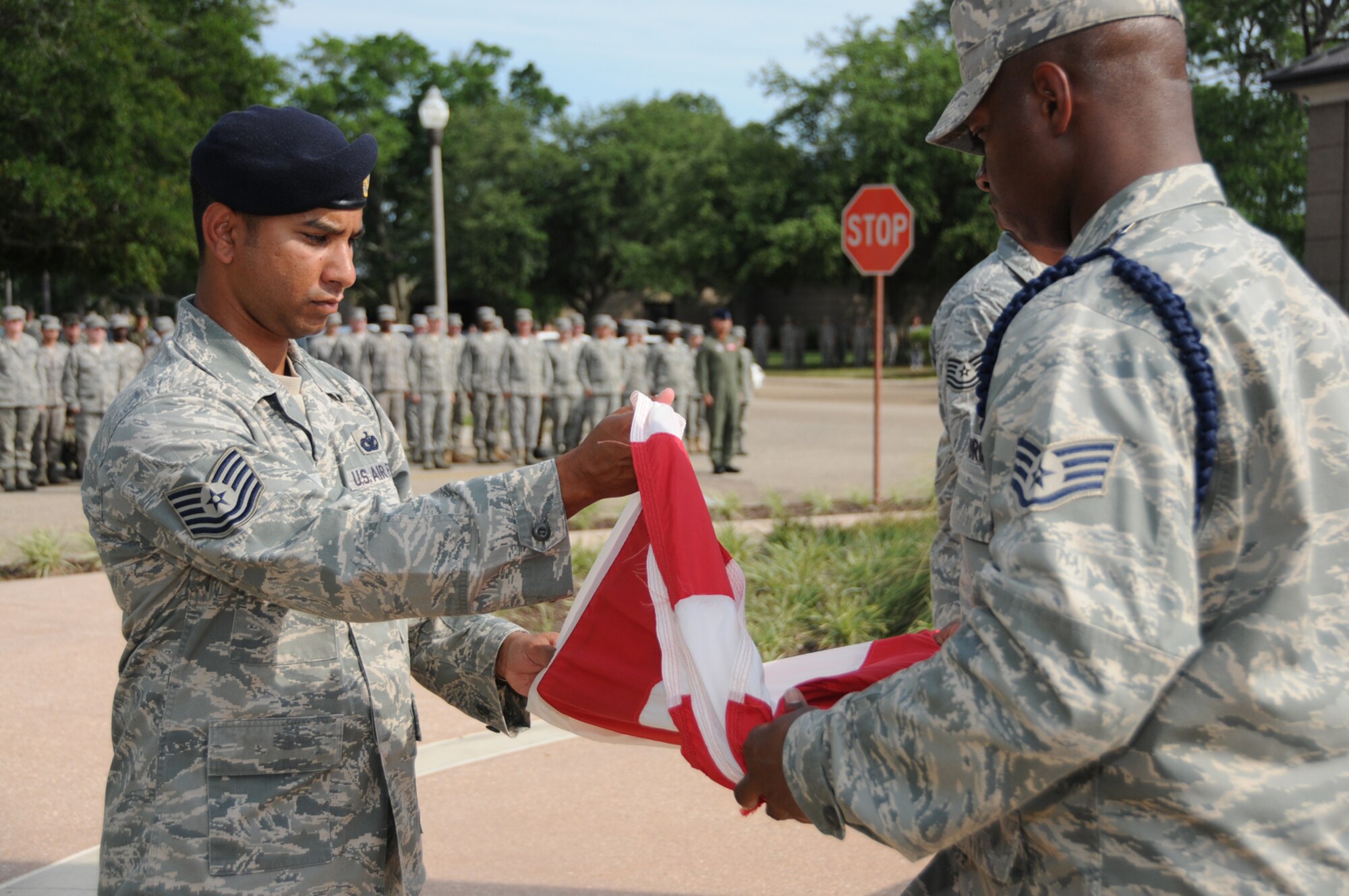 Tech. Sgt. Ezra Khan, Airman Leadership School, and Staff Sgt. Darnell Samuel, 335th Training Squadron, fold the flag at a May 28 retreat ceremony honoring the first Chief Master Sergeant of the Air Force Paul Airey.  Chief Airey, who died March 11, was interred at Arlington National Cemetery that day.  (U.S. Air Force photo by Kemberly Groue)