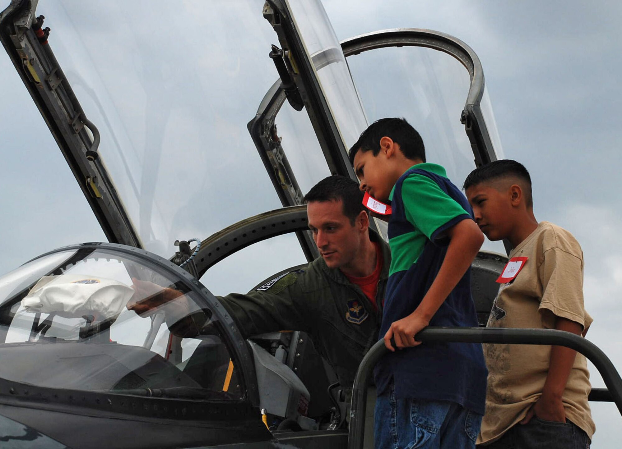 LAUGHLIN AIR FORCE BASE, Texas--Capt. Joel Thesing, 87th Flying Training Squadron Squadron and Laughlin Education Enrichment Program mentor, explains parts of the T-38 Talon to Ruben Chavira Elementary School students here May 29. The program, LEEP, was developed as way to help students excel in a non-threatening, motivating environment by pairing each student with a Laughlin Airman to be their mentor.  Twenty-five students participated in a base tour that was organized by the Laughlin mentors as a capstone event to end the school year and recognize the students' achievements.  (U.S. Air Force photo by Airman 1st Class Sara Csurilla)