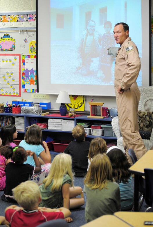 Lt. Col. Joe Alcorn, an HH-60G Pave Hawk pilot, speaks to his son's 2nd grade class at Gemini Elementary in Melbourne Beach, Fla. Colonel Alcorn and other reservists from the 920th Rescue Wing, Patrick Air Force Base, Fla., spent four months in Afghanistan supporting joint operations. Colonel Alcorn showed the class images of an Afghan school he visited. The Afghani children received school supplies donated by the 2nd graders. (U.S. Air Force photo/Master Sgt. Rob Grande)