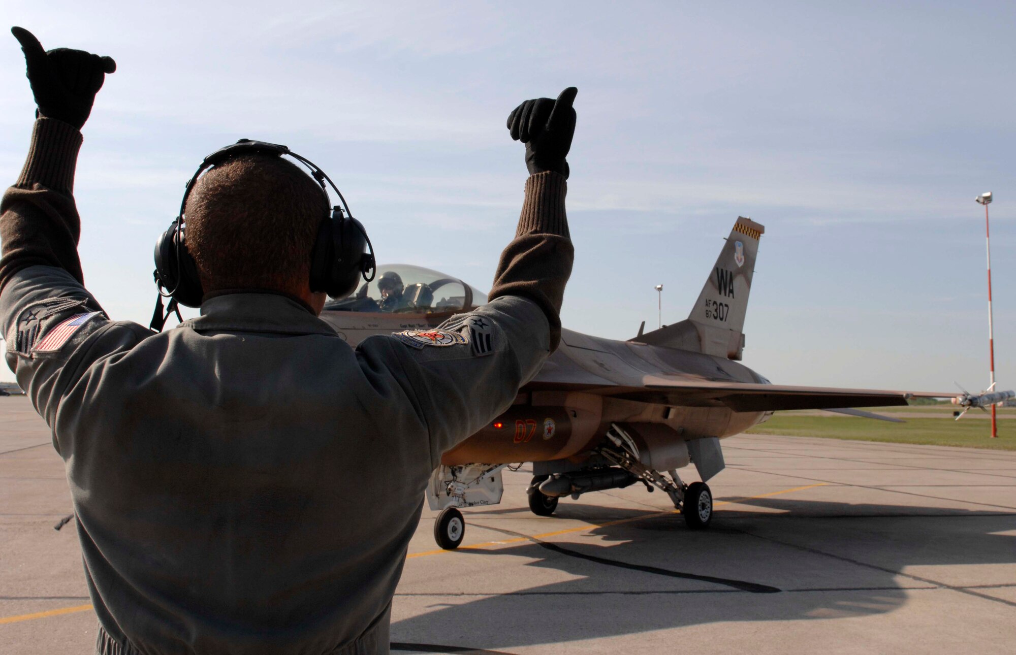 Senior Airman Alex Armstead, an F-16 Fighting Falcon Aggressor crew chief, assigned to the 57th Aircraft Maintenance Squadron, Nellis Air Force Base, Nev., prepare to marshal out Maj. Shawn Kellett, from the 64th Aggressor Squadron, during exercise Maple Flag 42 at 4 Wing Cold Lake, Canada, June 2. Maple Flag is a Canadian-sponsored and Air Combat Command supported exercise, that provides aircrews simulated air and ground combat training to coalition forces in a NATO environment.
(U.S. Air Force Photo/Senior Airman Larry E. Reid Jr., Released)