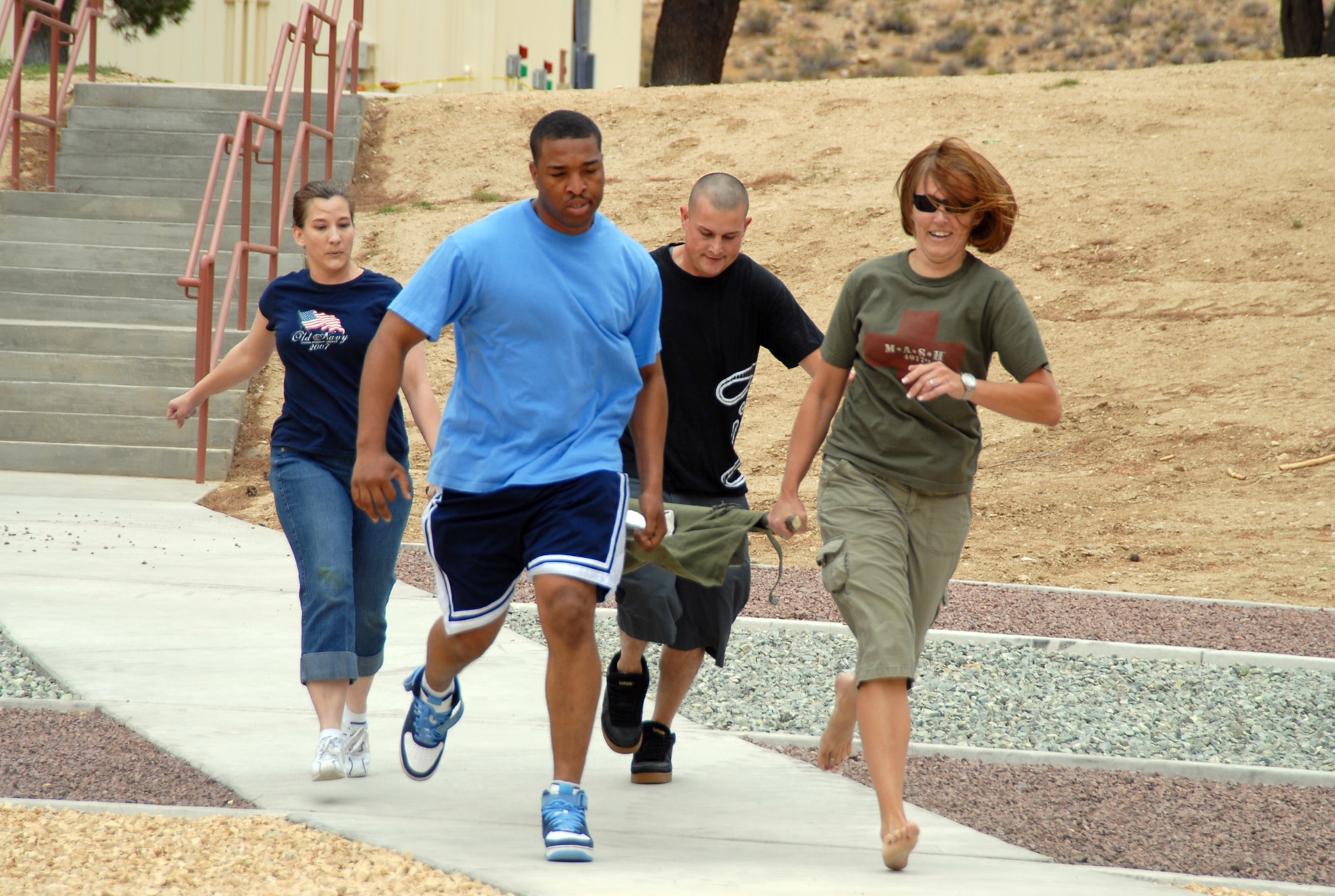 A team of medics participates in litter carry obstacle course competition during the 95th Medical Group Mash Bash May 29. Other games during the event include black jack tournaments, pushup and sit-up competitions, pass the orange game and picture contest. (U.S. Air Force photo/Senior Airman Julius Delos Reyes)