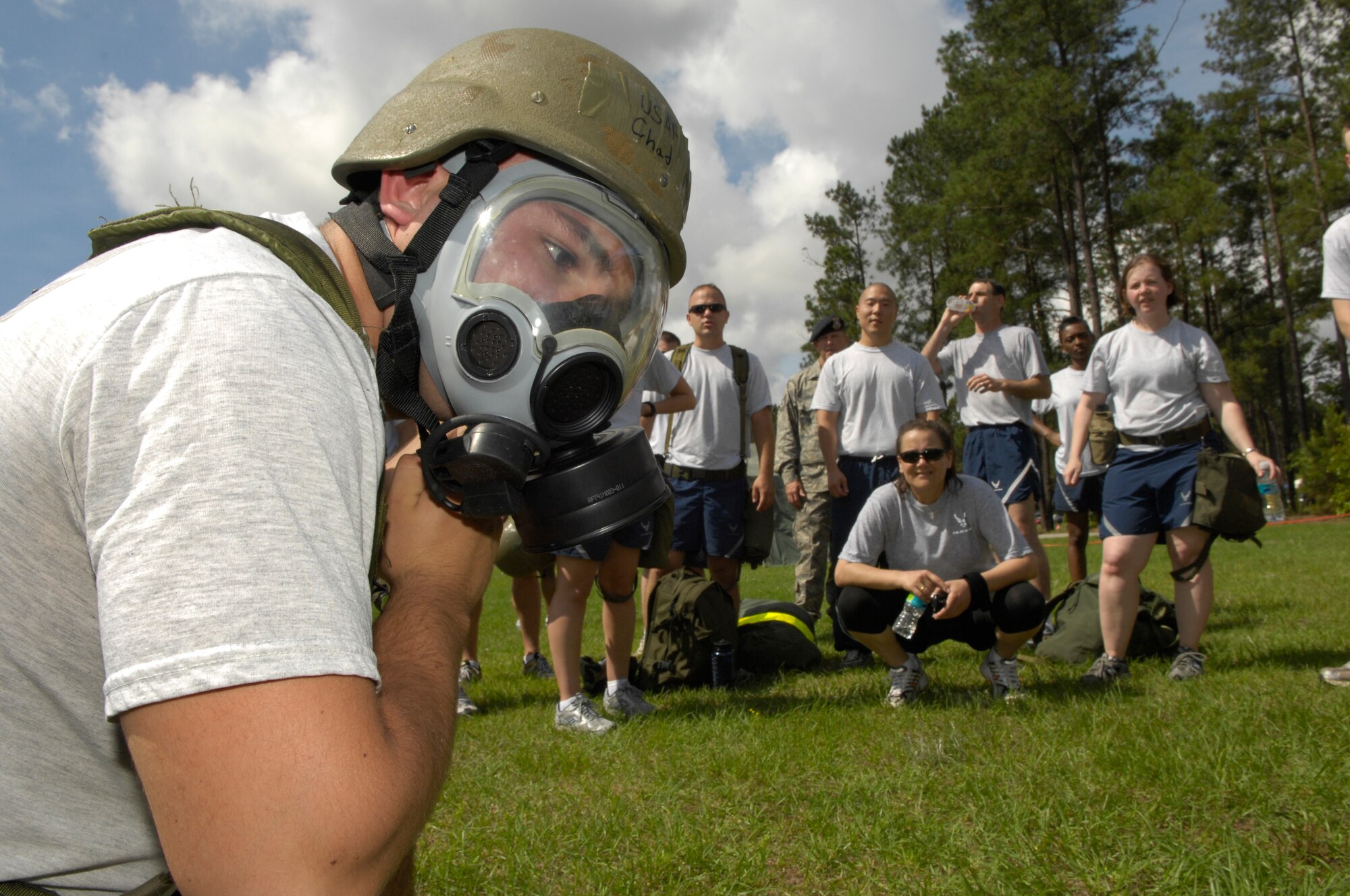 SHAW AIR FORCE BASE, S.C. -- Senior Airman Chad Michaud, 20th Contracting Squadron, competes in a gas mask donning competition during the 20th Mission Support Group Operational Readiness Inspection Combat Rally May 26, as his teammates cheer him on. The rally was comprised of combat-themed events and served as a refresher in Ability to Survive and Operate procedures for Shaw's ORI in June. (U.S. Air Force photo/Senior Airman Kathrine McDowell)
