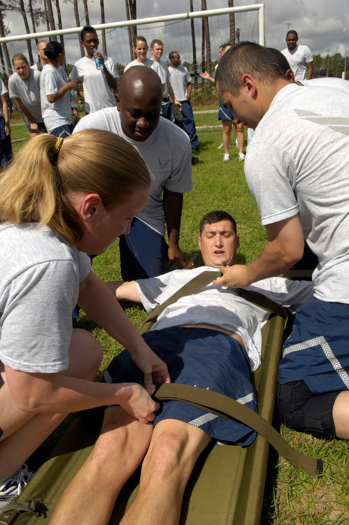 SHAW AIR FORCE BASE, S.C. -- First Lt. Christopher Bush is strapped down to a litter by other members of the 20th Force Support Squadron during the 20th Mission Support Group Operational Readiness Inspection Combat Rally May 26. The rally was comprised of combat-themed competitions that served as a refresher in Ability to Survive and Operate procedures for Shaw's ORI in June. (U.S. Air Force photo/Senior Airman Kathrine McDowell)