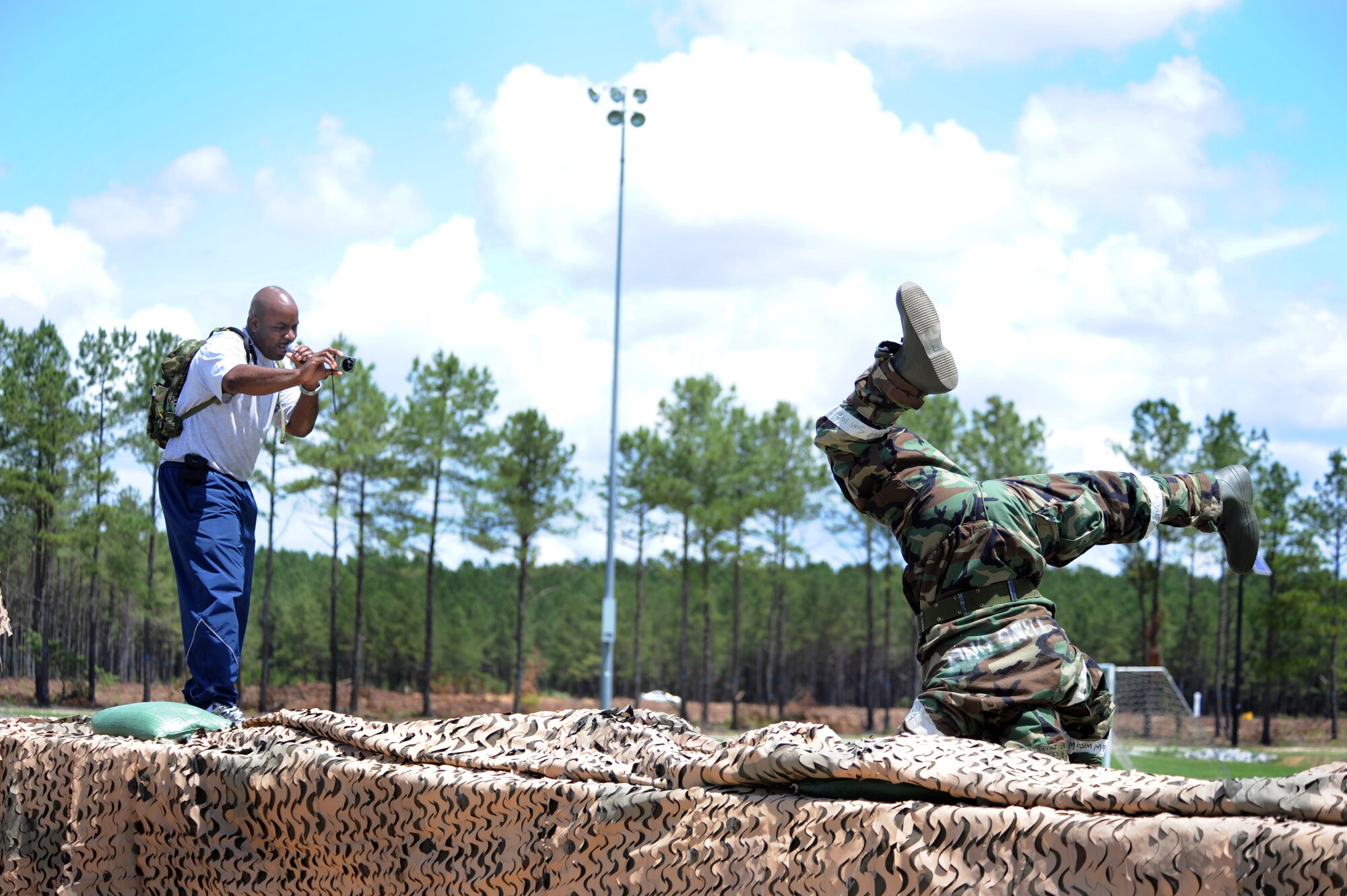 SHAW AIR FORCE BASE, S.C. -- Senior Master Sgt. Peter Smith, the master of ceremonies for the 20th Mission Support Group Operational Readiness Inspection Combat Rally, takes photos of break dancer Airman 1st Class Daniel Alicea, 20th Security Forces Squadron, also known as 'BBOY-D,' and the Mission Oriented Protective Posture 4 dance winner, May 26. The MOPP 4 dance was one of several combat-themed competitions that allowed 20th MSG personnel to have fun as they trained for the June ORI. (U.S. Air Force photo/Senior Airman Matt Davis)