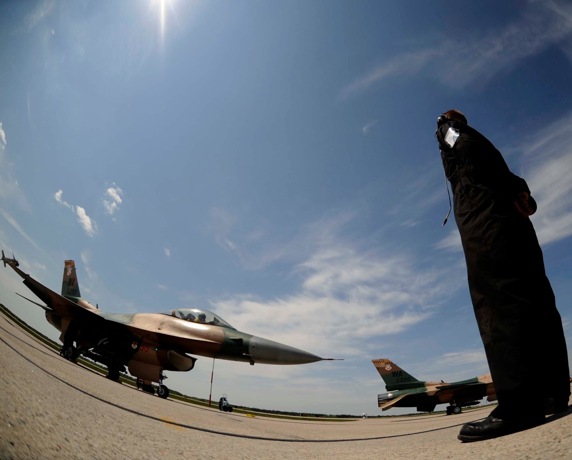 Senior Airman Jason Patterson, an F-16 Fighting Falcon Aggressor crew chief, assigned to the 57th Aircraft Maintenance Squadron, Nellis Air Force Base, Nev., prepare to marshal out Capt. Patrick Bagan, assigned to the 64th Aggressor Squadron during exercise Maple Flag 42 at 4 Wing Cold Lake, Canada, June 2. Maple Flag is a Canadian-sponsored and Air Combat Command supported exercise, that provides aircrews simulated air and ground combat training to coalition forces in a NATO environment.
(U.S. Air Force Photo/Senior Airman Larry E. Reid Jr., Released)