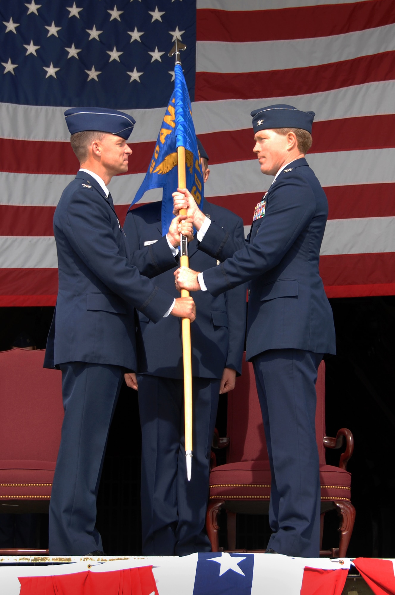Col. Mark Dillon, 60th Air Mobility Wing commander, hands the 60th Operations Group Guideon to Col. Anthony Butters during a change of command ceremony June 1 on the flightline. (U.S. Air Force photo/Nan Wylie)