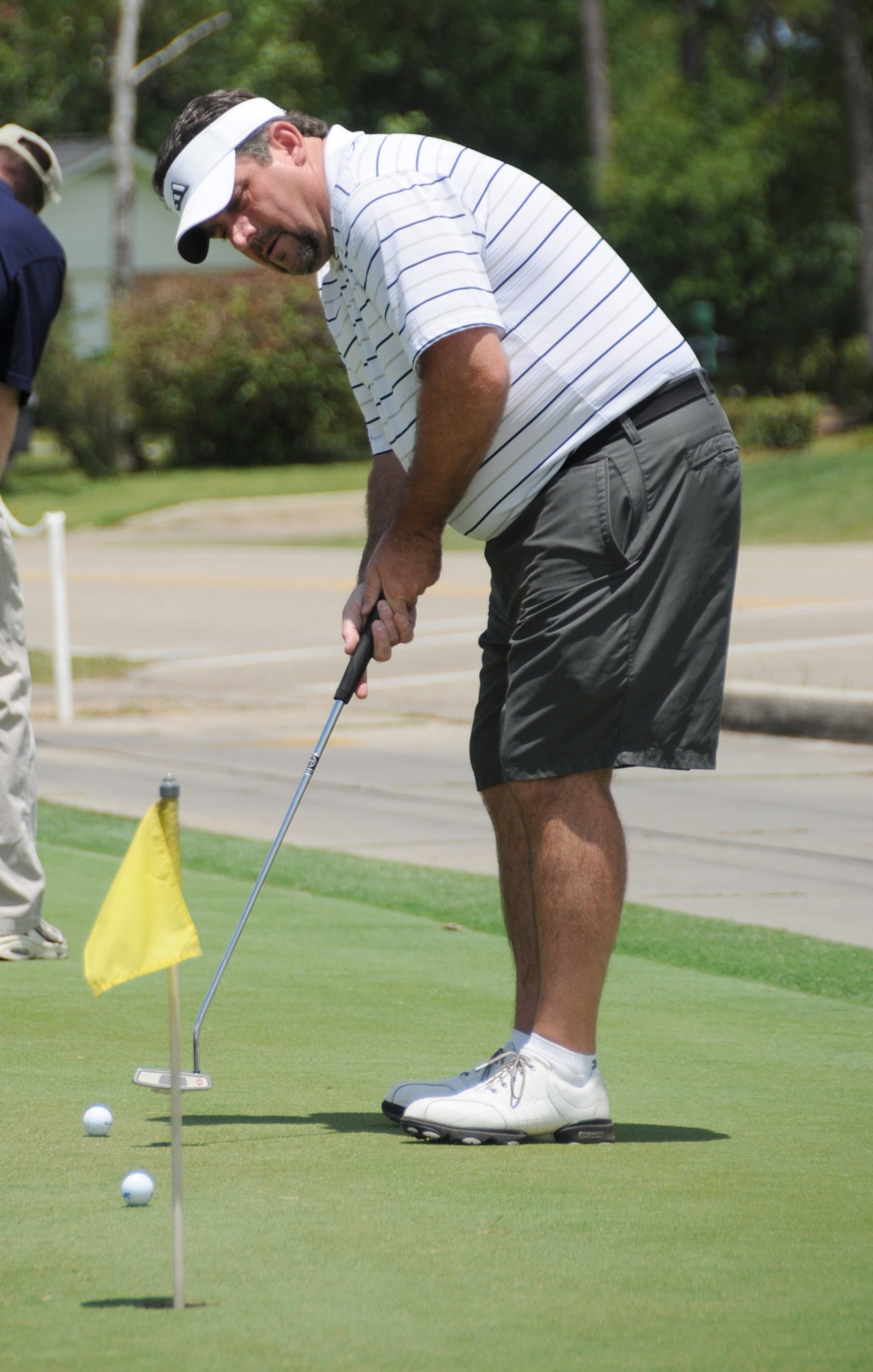 Bill Bacon, 333rd Training Squadron, practices his putts.  (U.S. Air Force photo by Kemberly Groue)
