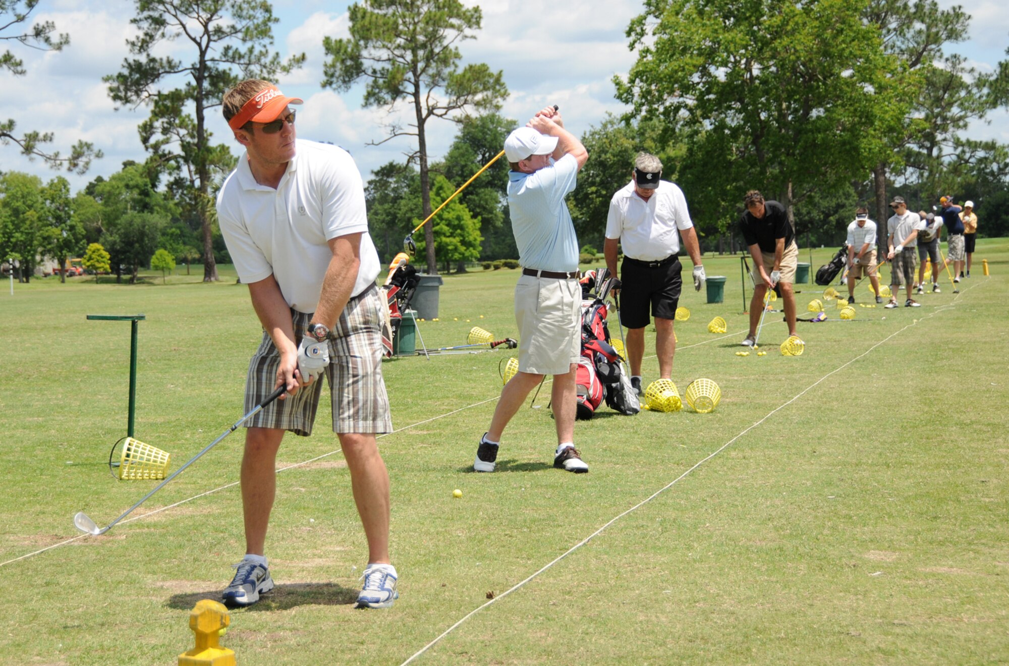 From left, ?Chris Hebert, playing for the Biloxi Bay Chamber of Commerce; Gary Schafer, 81st Force Support Squadron, playing for the Keesler team, and other golfers warm up Friday on the driving range for the annual Keesler vs. Biloxi Bay Chamber golf tournament at Sunkist Country Club.  Keesler successfully defended its title, 36.5 to 26.5.  (U. S. Air Force photo by Kemberly Groue)