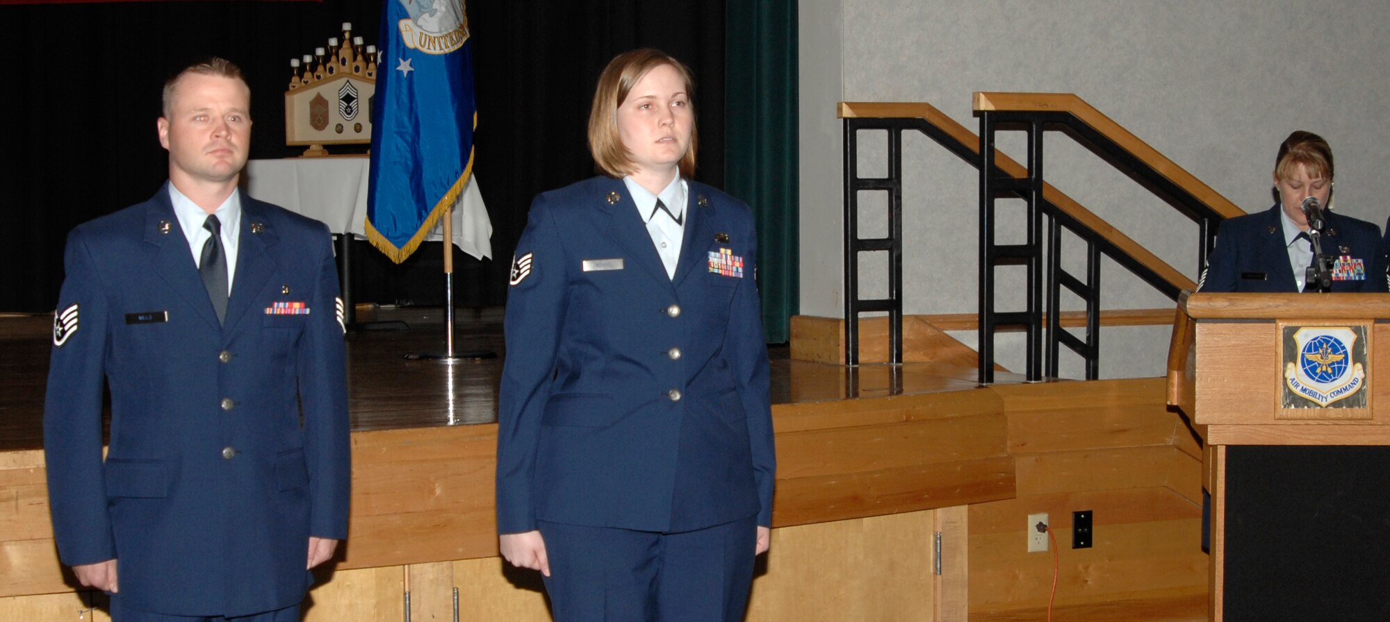 MCCONNELL AIR FORCE BASE, Kan. -- Newly promoted Staff Sgt. Daniel Mills, 22nd Air Refueling Wing command chief executive, and Staff Sgt. Anna Norris, 22nd Force Support Squadron, take the non-commissioned officer oath during the wing promotion ceremony in the Robert J. Dole Community Center ballroom, May 28. The oath signifies individuals moving up in rank to assume stronger roles and responsibilities in their work areas and in the Air Force. (Photo by Senior Airman Laura Suttles)