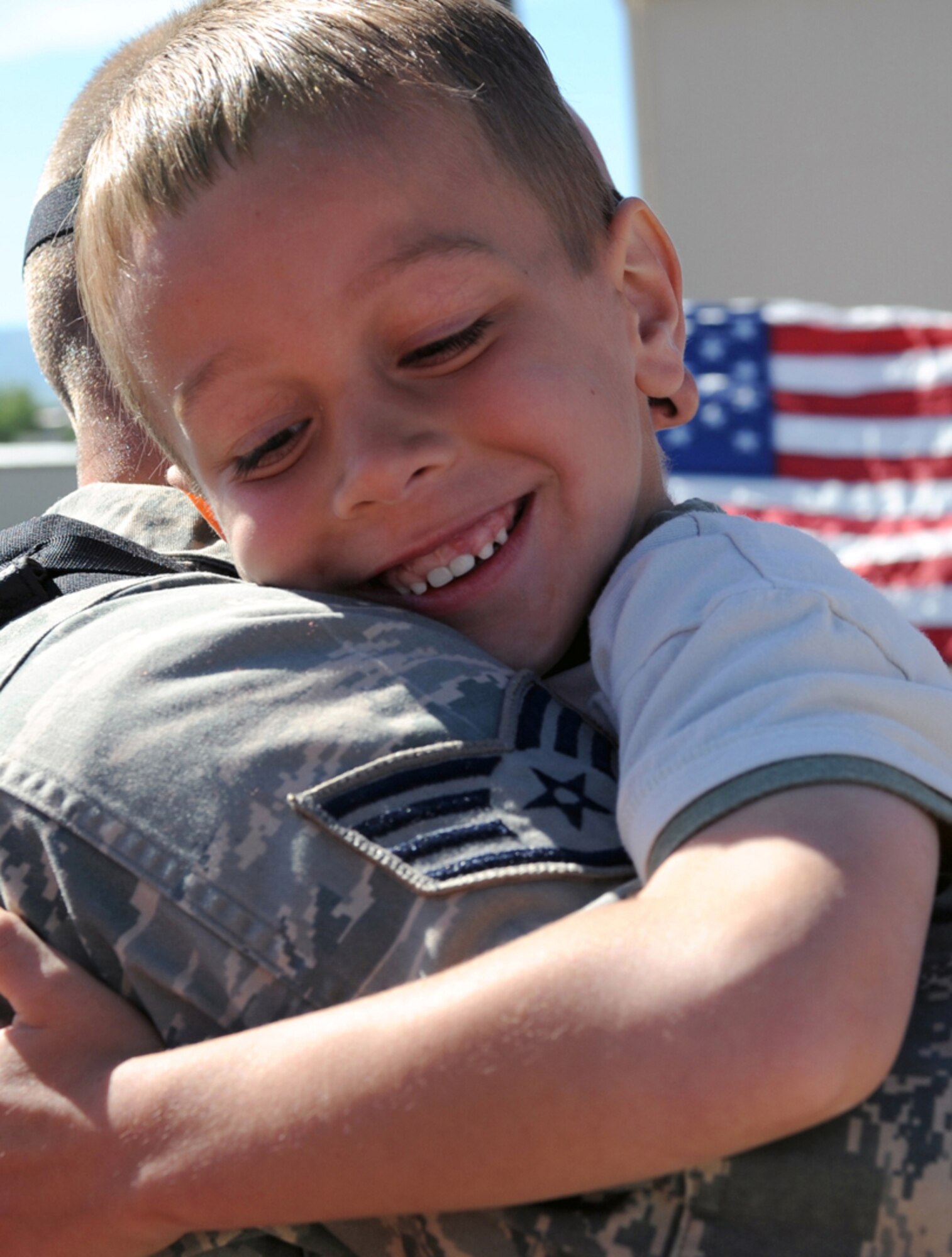 Brayden Flink hugs his father, Staff Sgt. Jacob Flink, a 419th Aircraft Maintenance Squadron crew chief, upon his return to Hill Air Force Base, Utah, May 28, 2009. Sergeant Flink was among nearly 300 Airmen from the 419th and 388th Fighter Wings who returned after a four-month deployment in support of Operation Iraqi Freedom. (U.S. Air Force photo/Staff Sgt. Kyle Brasier)