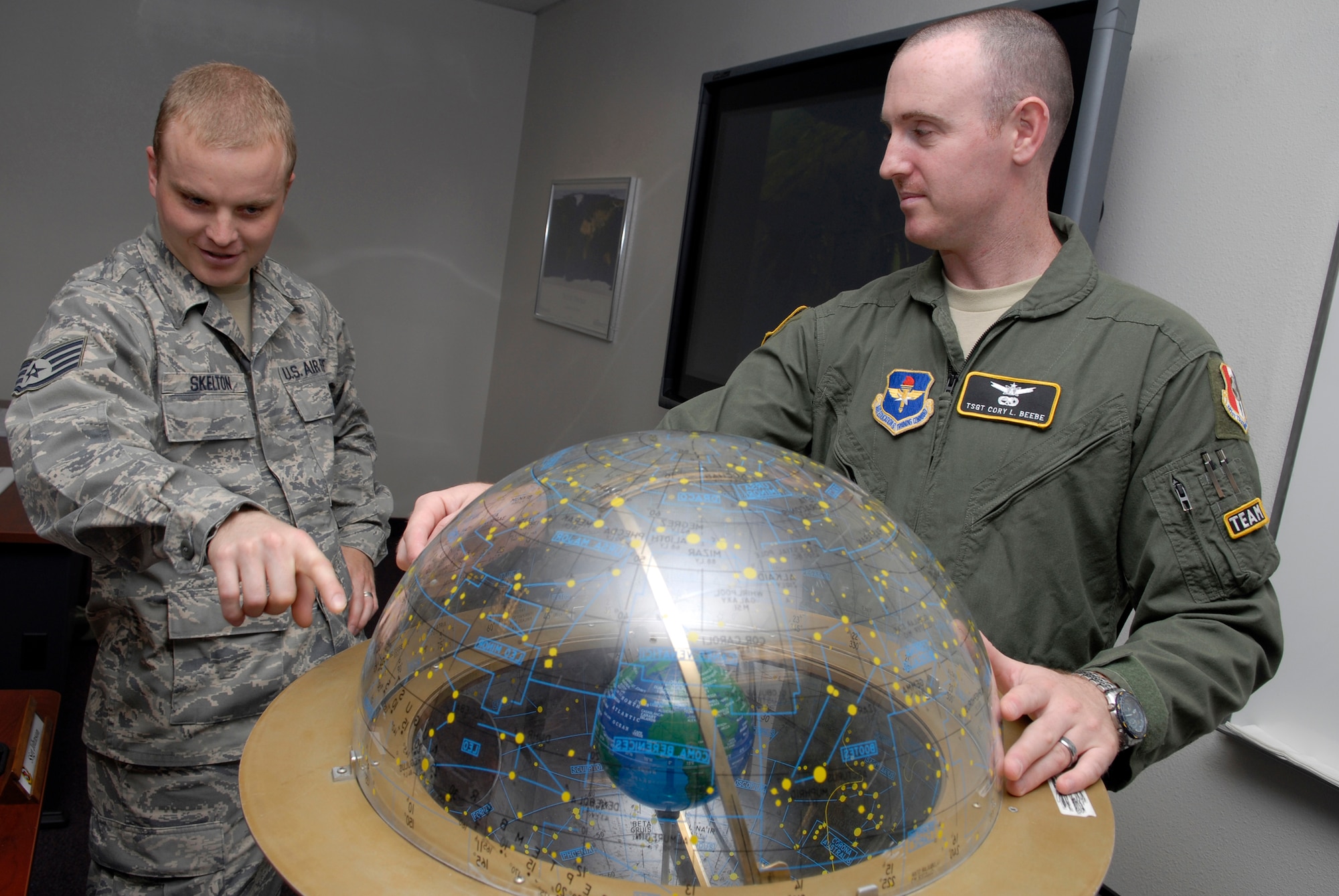 VANDENBERG AIR FORCE BASE, Calif. -- Using a celestial sphere, Staff Sgt. Dallin Skelton, left, a 533rd Training Squadron student, shows Tech. Sgt. Cory Beebe, a 533rd TRS enlisted Space 100 instructor, a point used to see the apparent path the sun takes through the stars. The 533rd TRS, an original missile squadron and a training detachment at Schriever AFB, Colo., provides initial qualification training for attack warning, space surveillance and counter-drug missions. (U.S. Air Force photo/Senior Airman Christian Thomas)