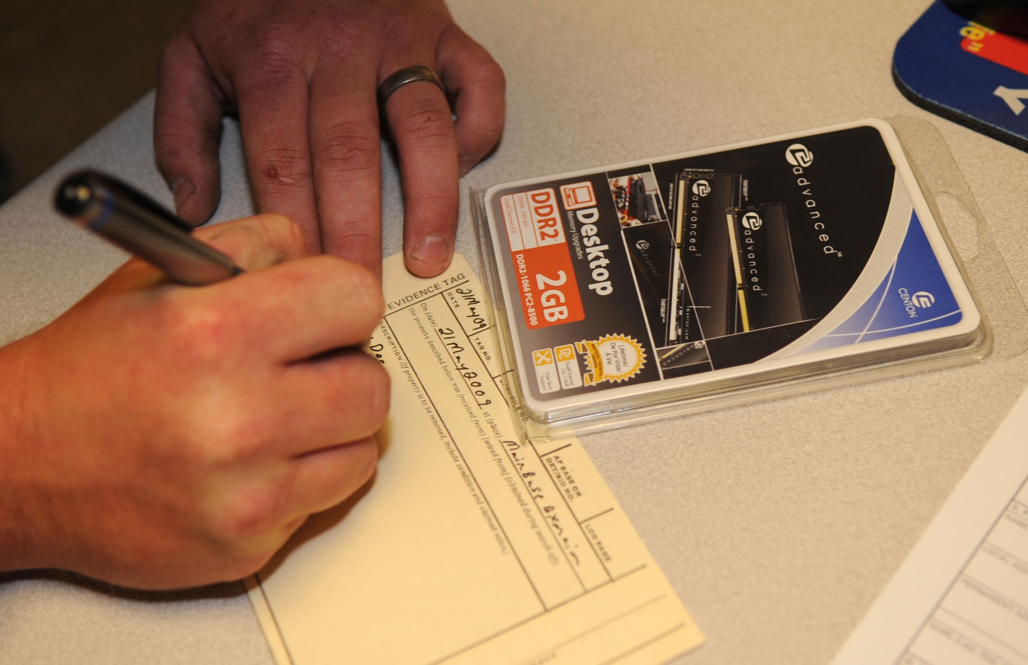 BARKSDALE AIR FORCE BASE, La. -- Senior Airman Michael Michel, 2d Security Forces Squadron writes an evidence tag for the stolen merchandise at the Barksdale Main Exchange, May 21. (United States Air Force photo by Senior Airman Alexandra Sandoval) (RELEASED)