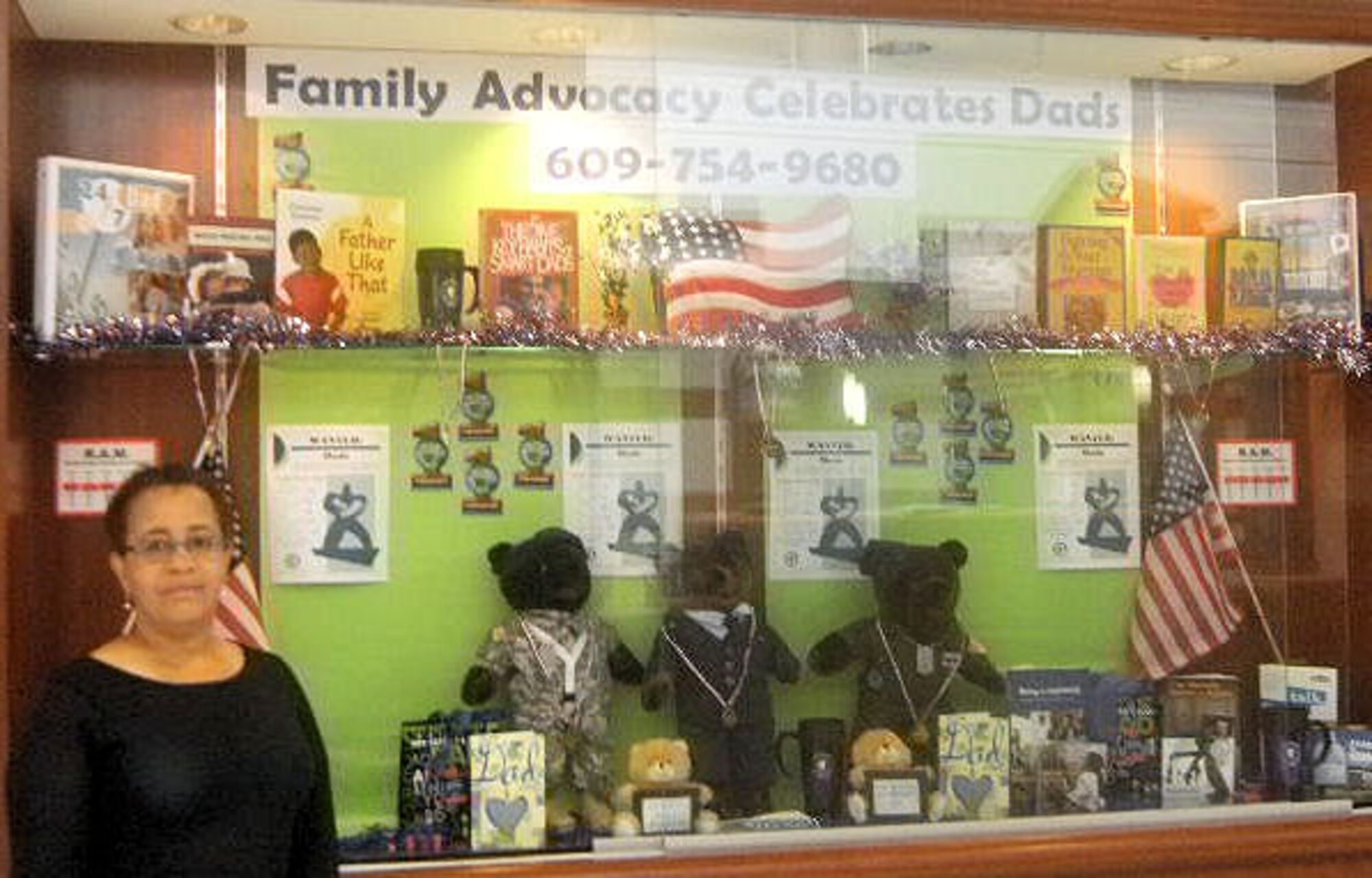 Melodye Giovanni, Family Advocacy Outreach Manager, stands in front of a display at the Medical Clinic on Joint Base McGuire-Dix-Lakehurst. The Family Advocacy center is celebrating Father’s Day this June by honoring military dads. The center offers family-oriented classes year-round. (U.S. Air Force courtesy photo)