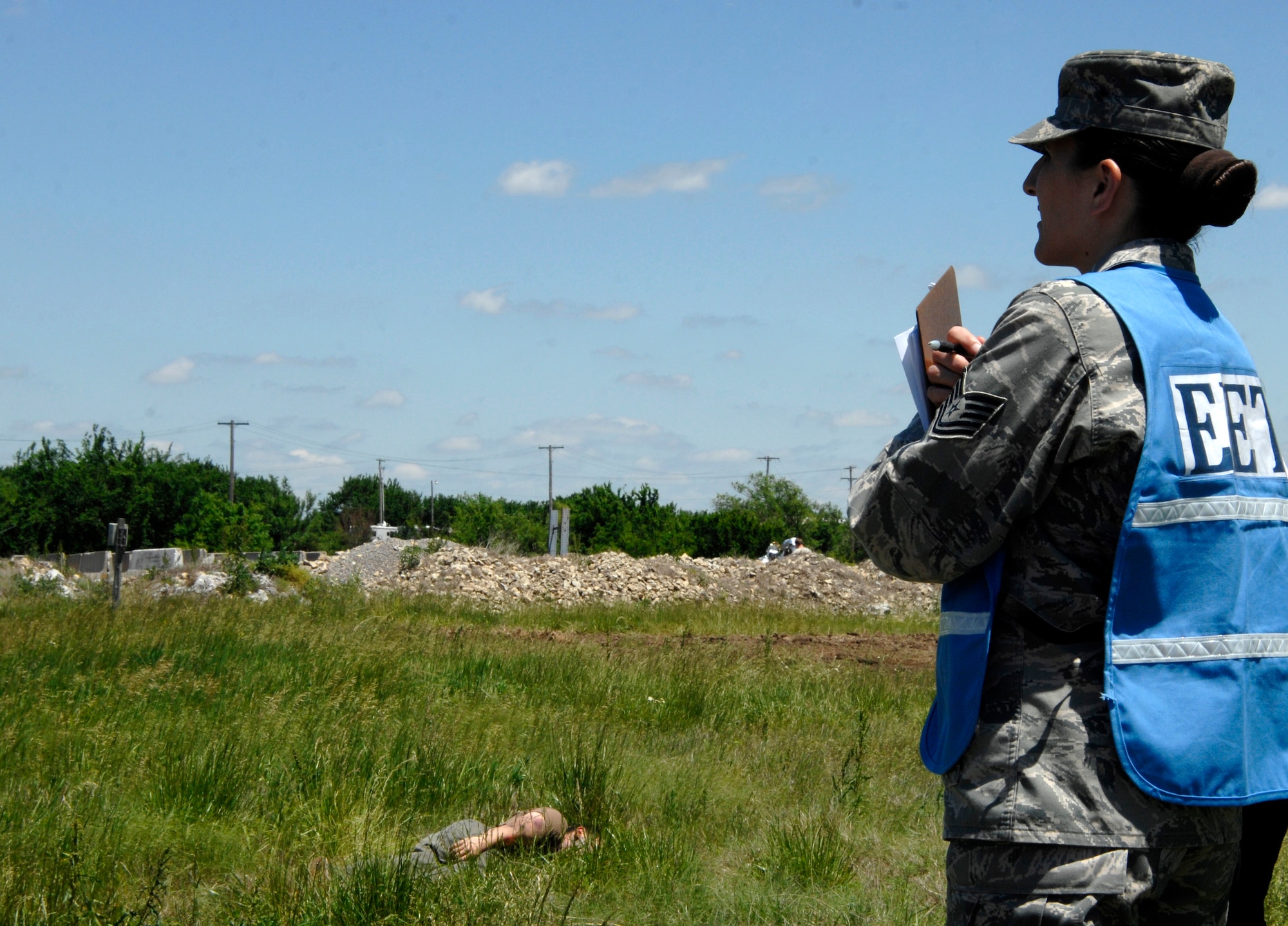 MCCONNELL AIR FORCE BASE, Kan. -- Tech. Sgt. Tiffany Shaffer, 22nd Medical Operations Squadron, participates as a exercise evaluation team member during an All Hazards Response training exercise at the base obstacle course, May 28. The scenario was a vehicle encountered an explosion and multiple people were injured. This exercise required the fire department, medical, explosive ordnance, and hazard material teams to respond. (Photo by Senior Airman Laura Suttles)